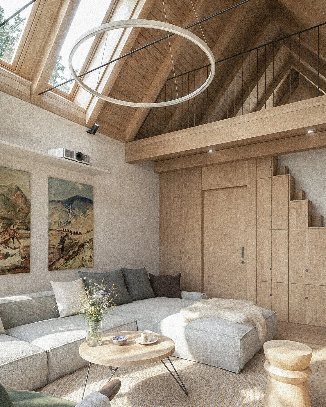 Living room with high wooden ceiling, skylights, a white sectional sofa with gray and dark pillows, a round wooden coffee table with a vase of flowers, artwork on the wall, and a wooden staircase leading to an upper loft.