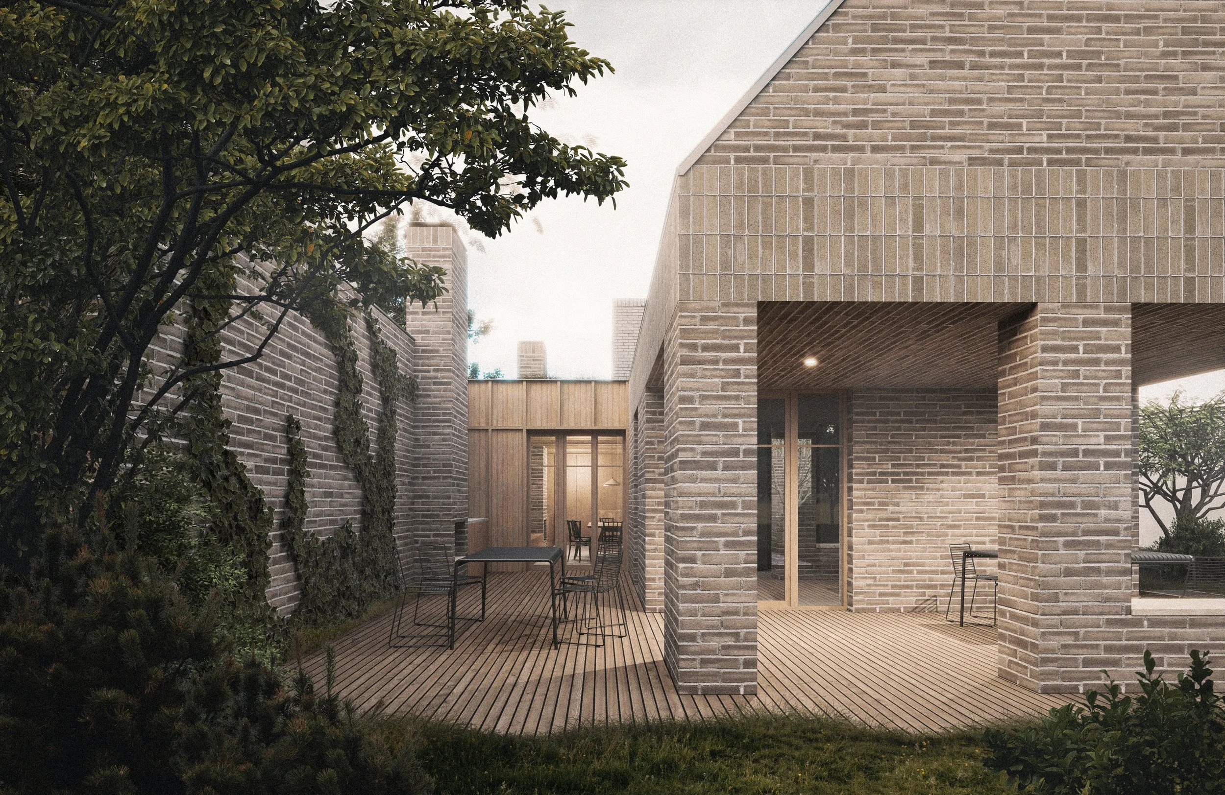 Modern brick house with a wooden deck patio area featuring a table and chairs, surrounded by greenery and a brick wall, during the daytime.