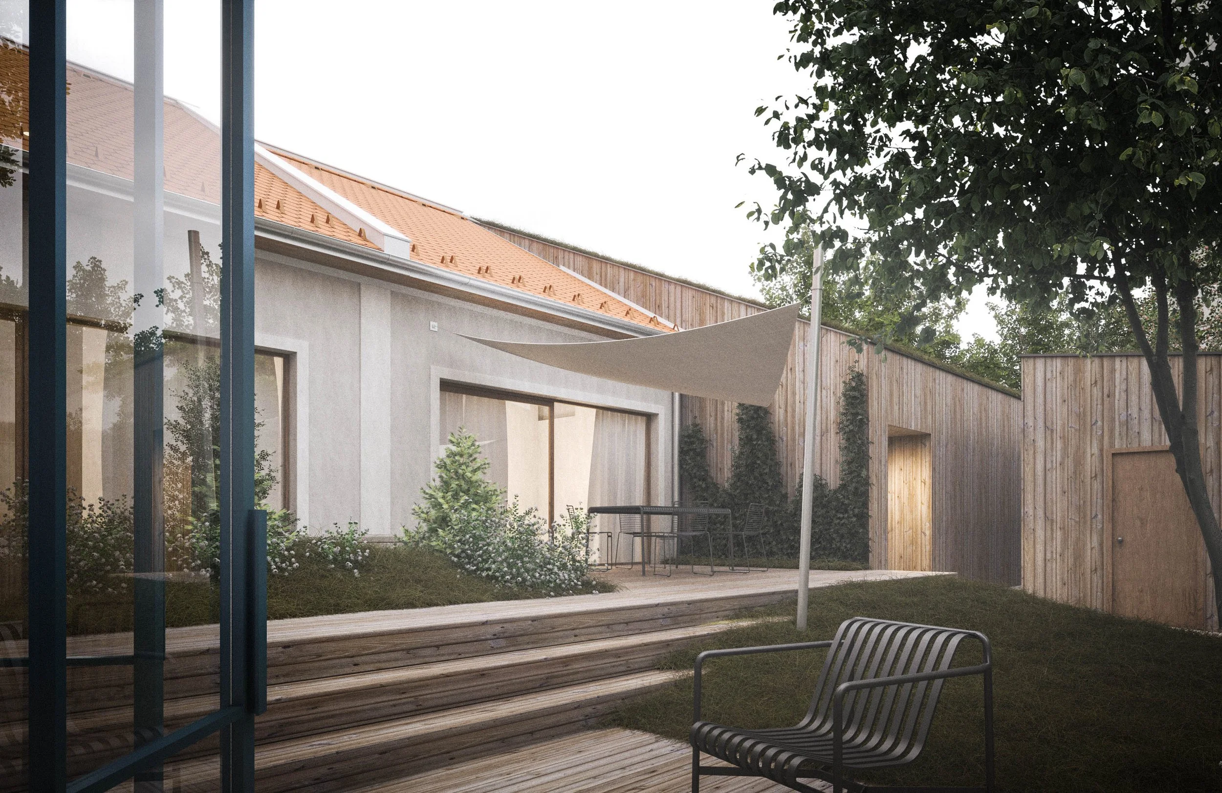 Backyard with wooden deck, outdoor furniture, a shade sail, and trees in the background.