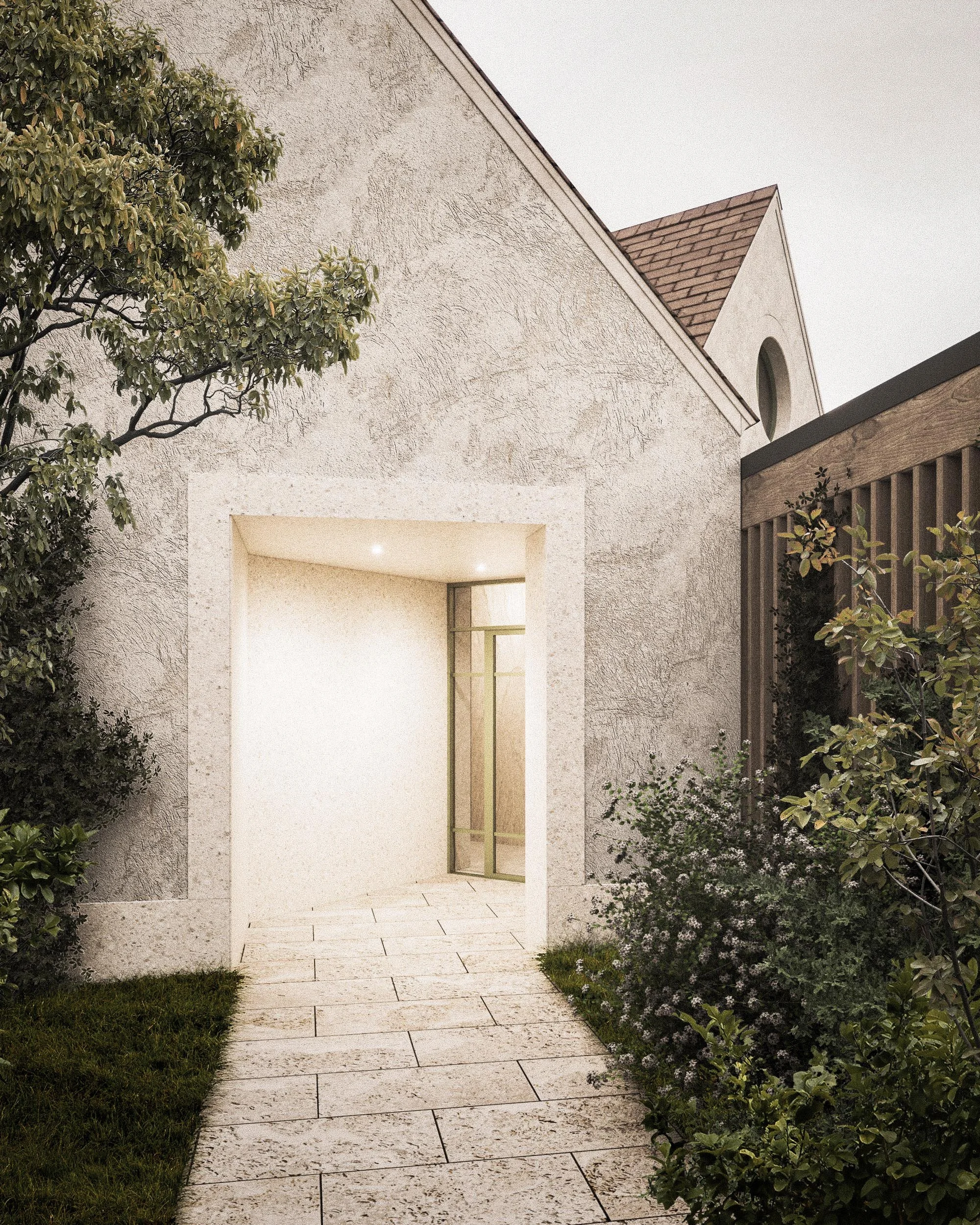 A view of a house exterior showing a stucco wall and a porch archway, with a pathway of light-colored paving stones leading to the entrance, flanked by green plants and a fence on the right side.