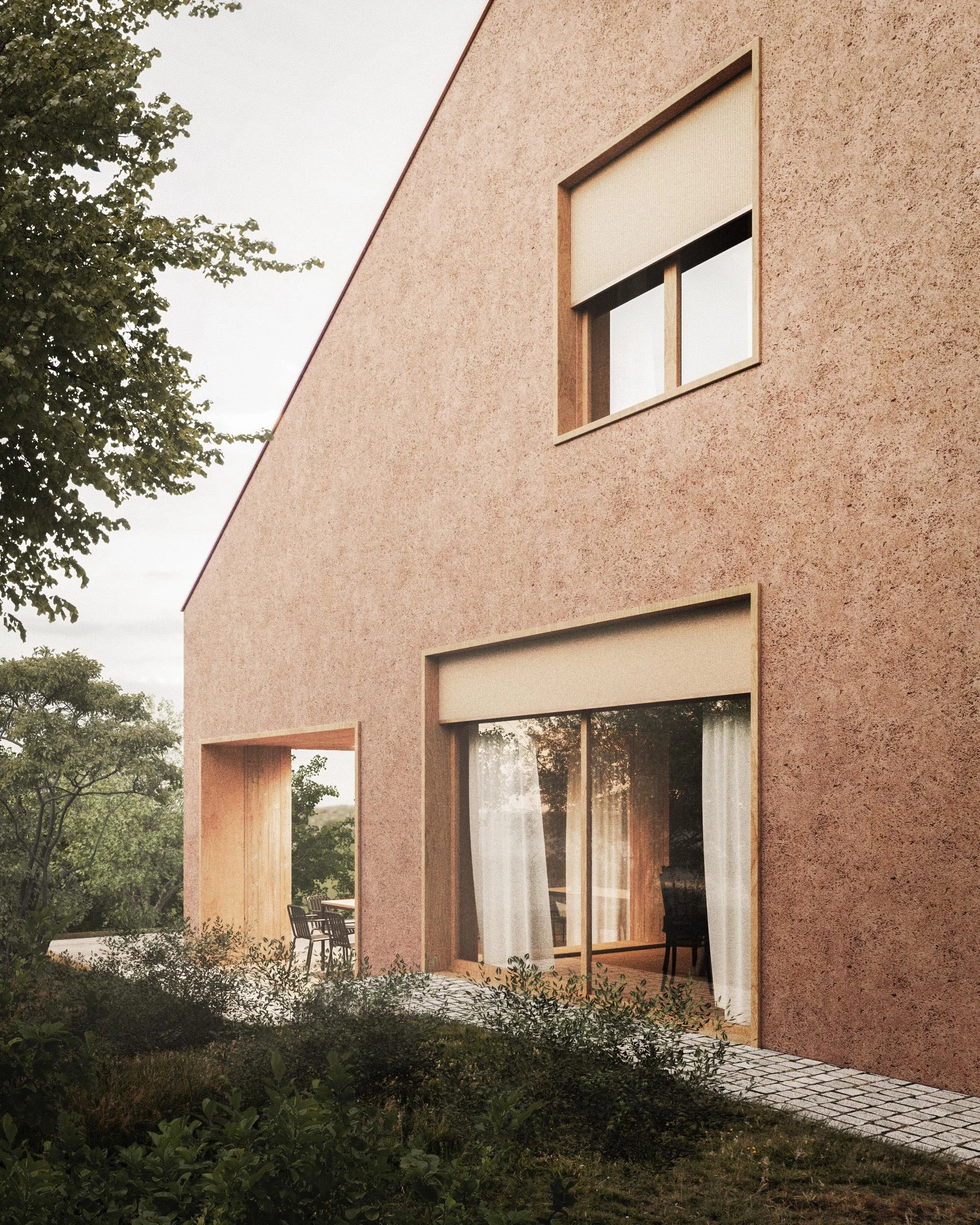 Modern house with large sliding glass doors, textured pinkish exterior walls, and a small outdoor patio area with chairs, surrounded by greenery and trees.