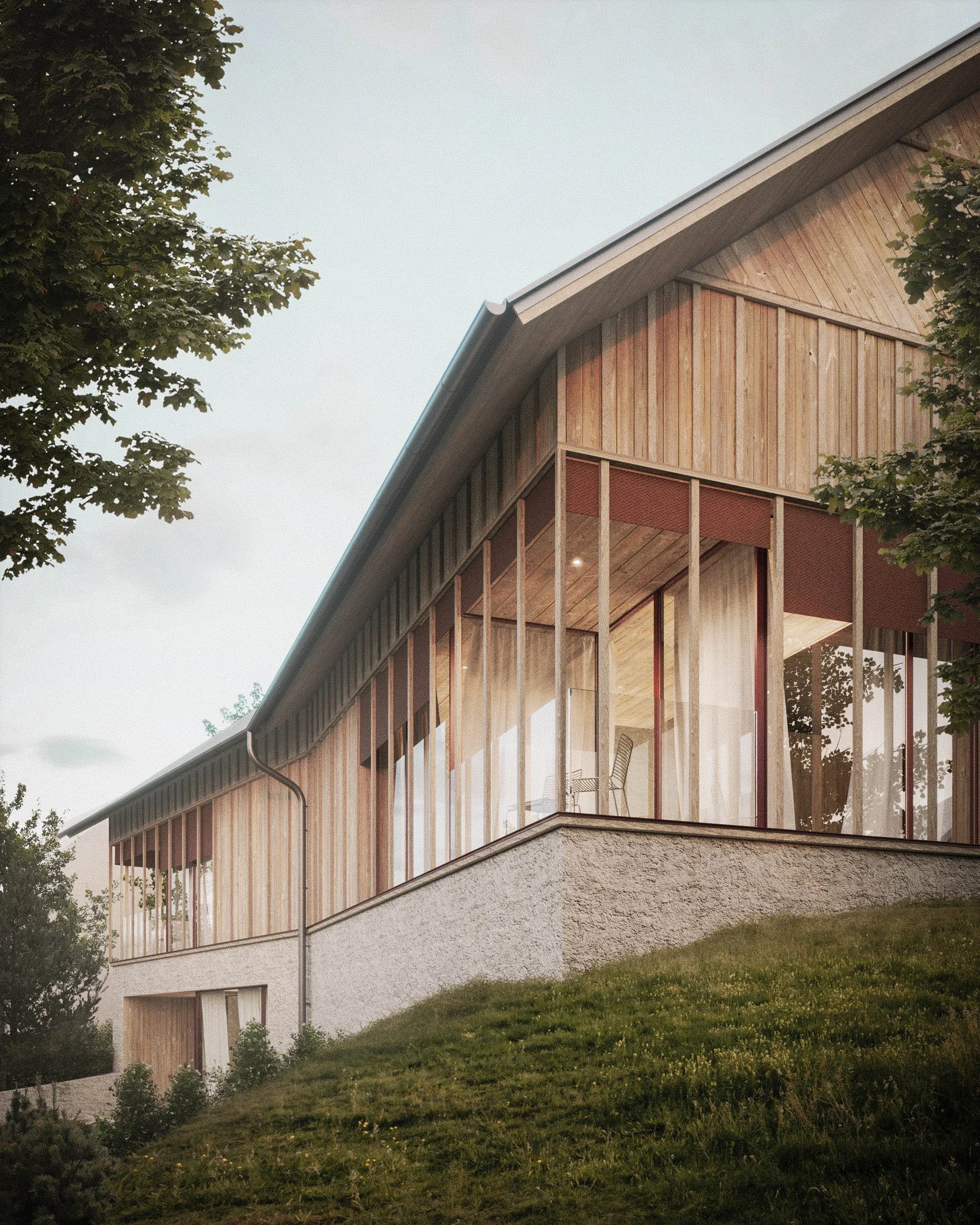 A modern multi-story house with a sloped roof and large glass windows, surrounded by green grass and trees, during dusk or early evening.