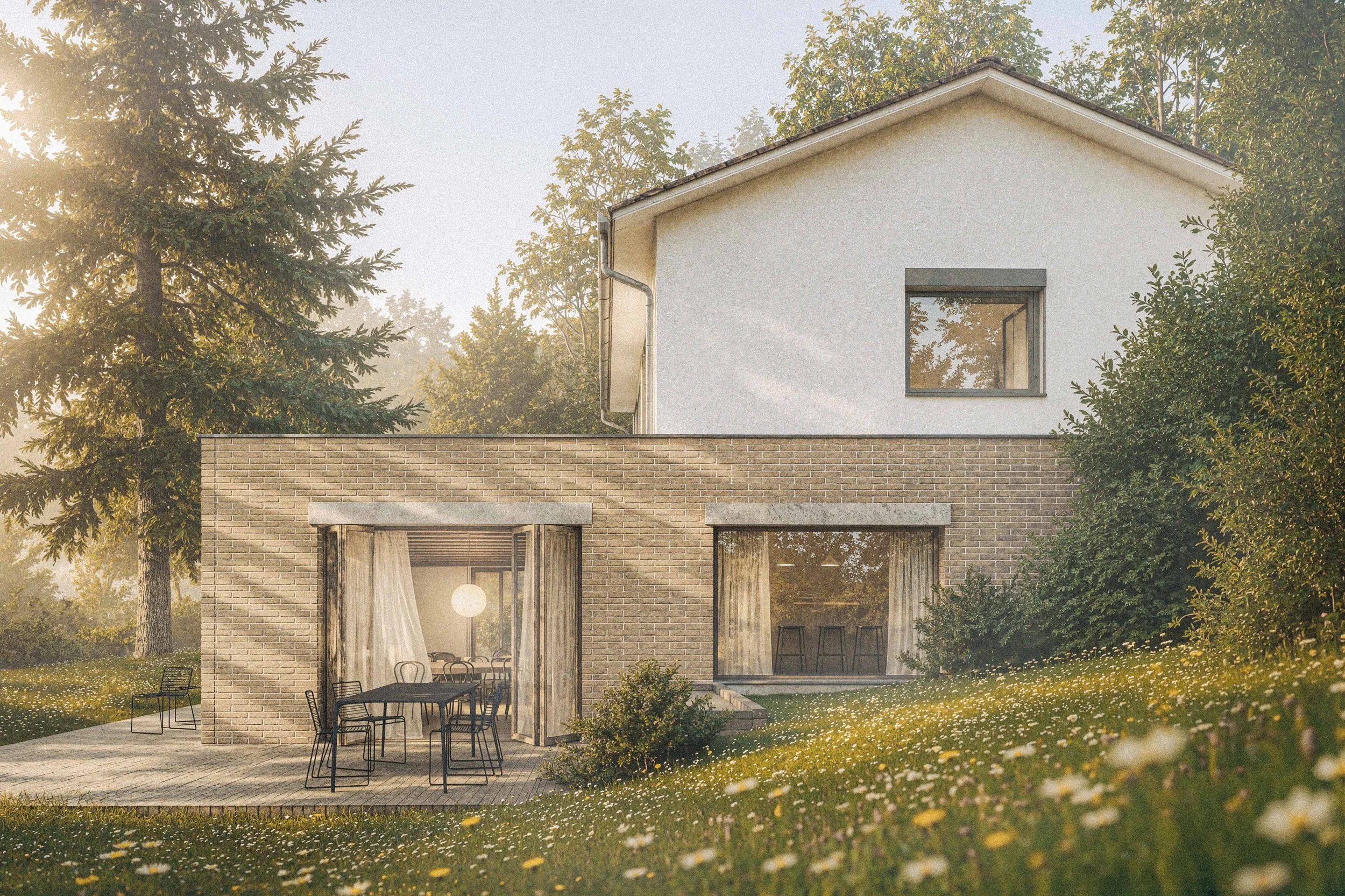 Modern house with large windows, surrounded by trees and a lawn with yellow flowers, with outdoor dining furniture on a patio.