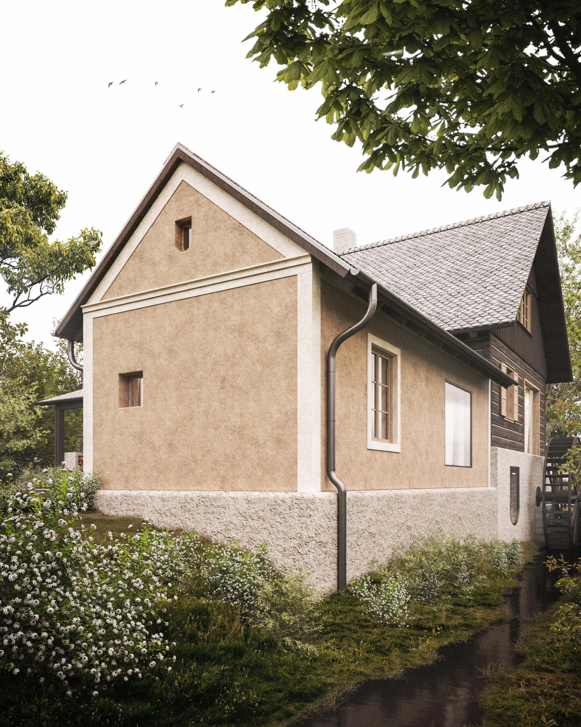 A two-story house with beige stucco exterior walls, brown window frames, and a grey tiled roof, surrounded by lush green trees and white flowering plants in the garden.