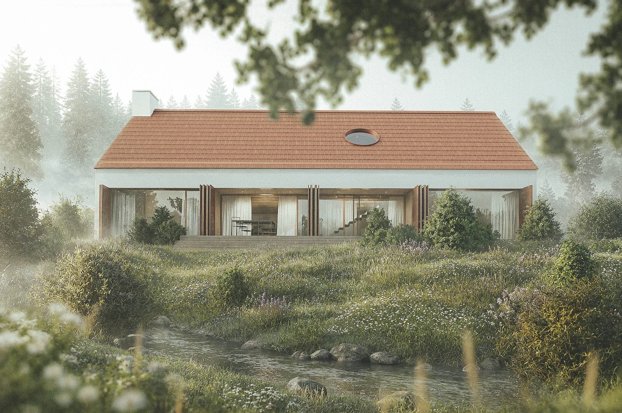 A house with a red-tiled roof and large glass doors, surrounded by lush greenery, with a small water stream in the foreground and tall trees in the background, partially obscured by blurred tree branches.
