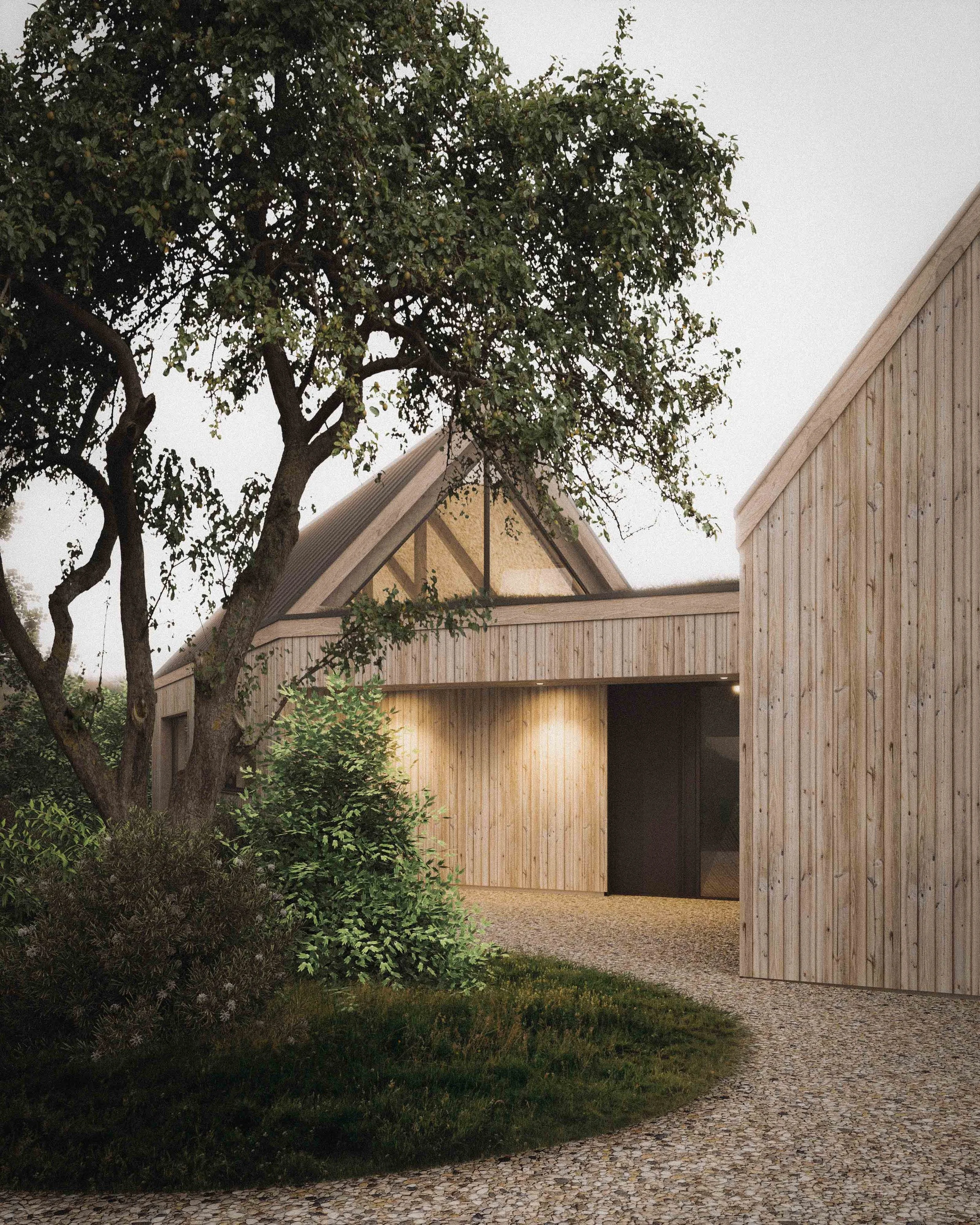 A modern wooden house with a sloped roof, situated among greenery, with a cobblestone driveway leading up to it. There is a tree with lush leaves in the foreground.