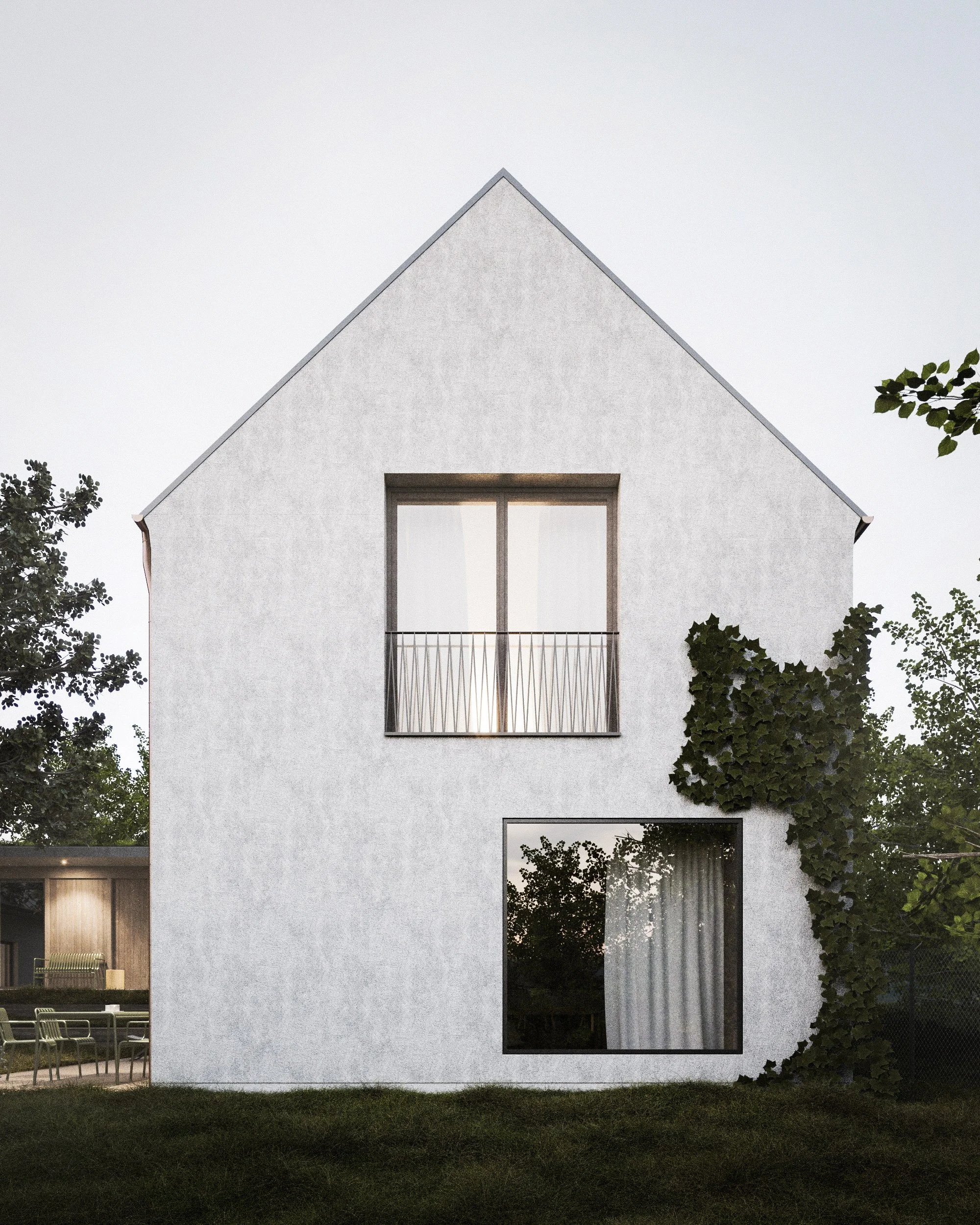 Modern white house with large windows, surrounded by trees and a grassy yard.