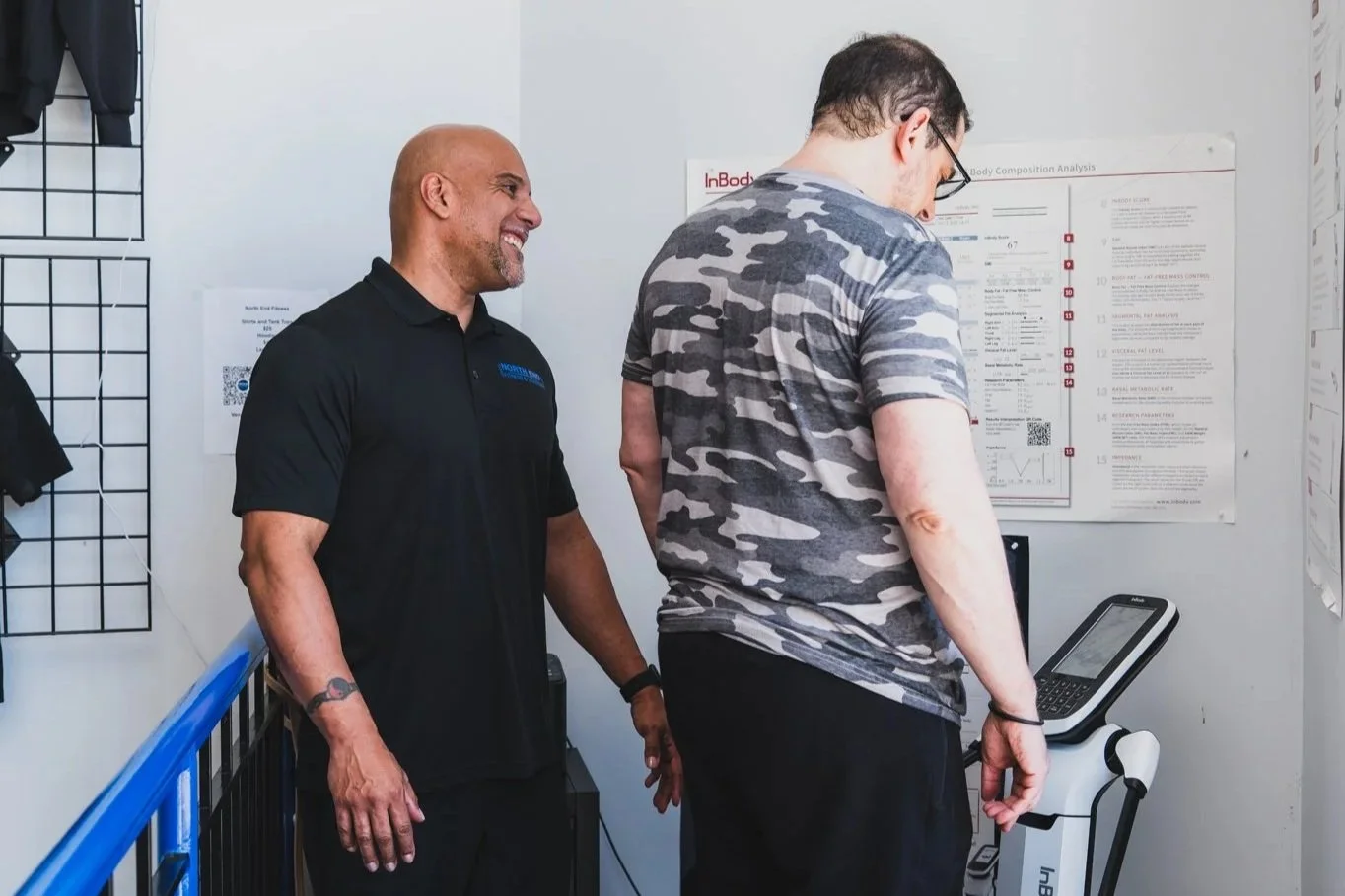Personal trainer helping a client on the InBody machine for body composition analysis
