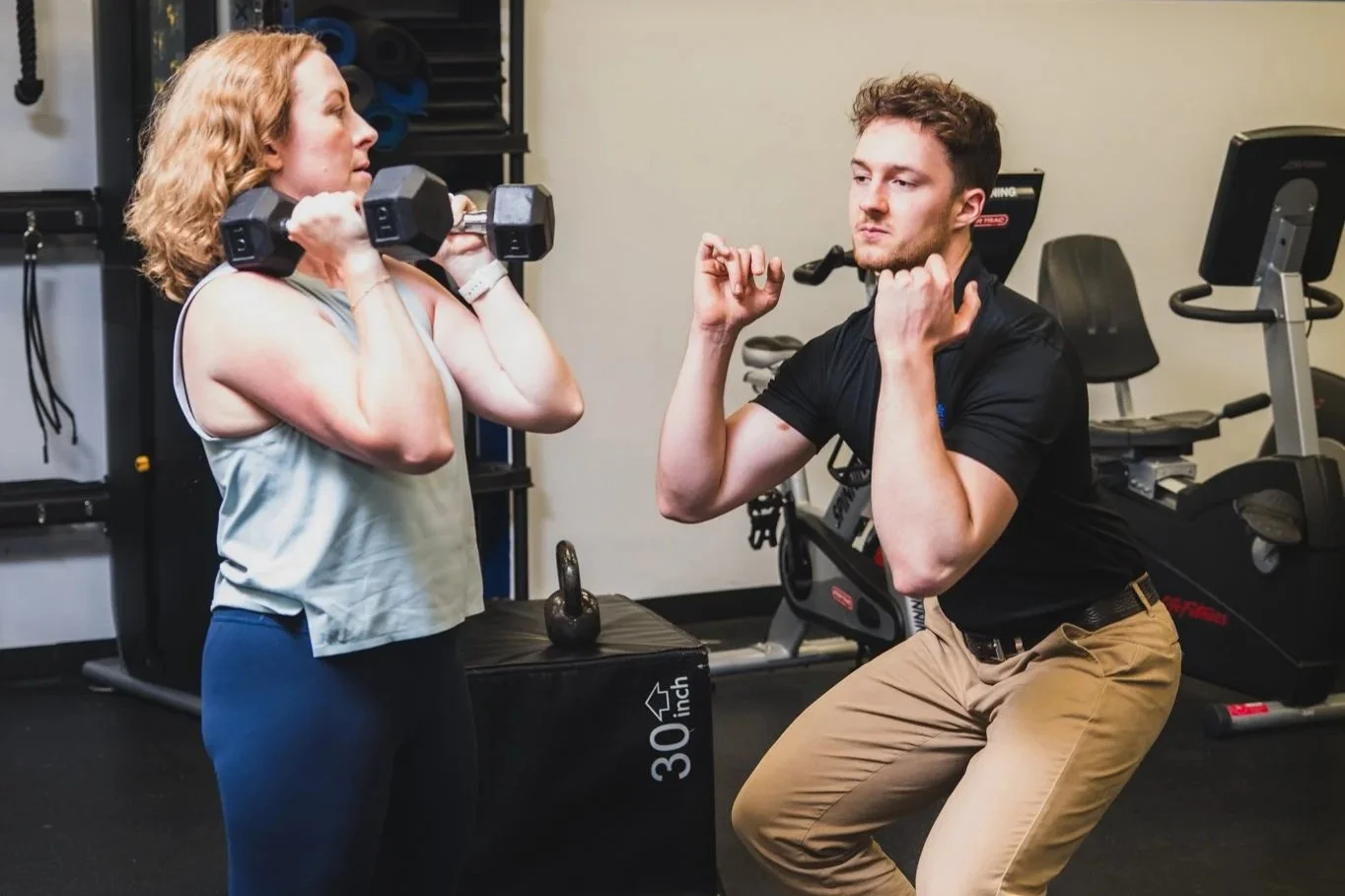 Personal trainer coaching a female client through a strength session at North End Fitness in New Rochelle, NY