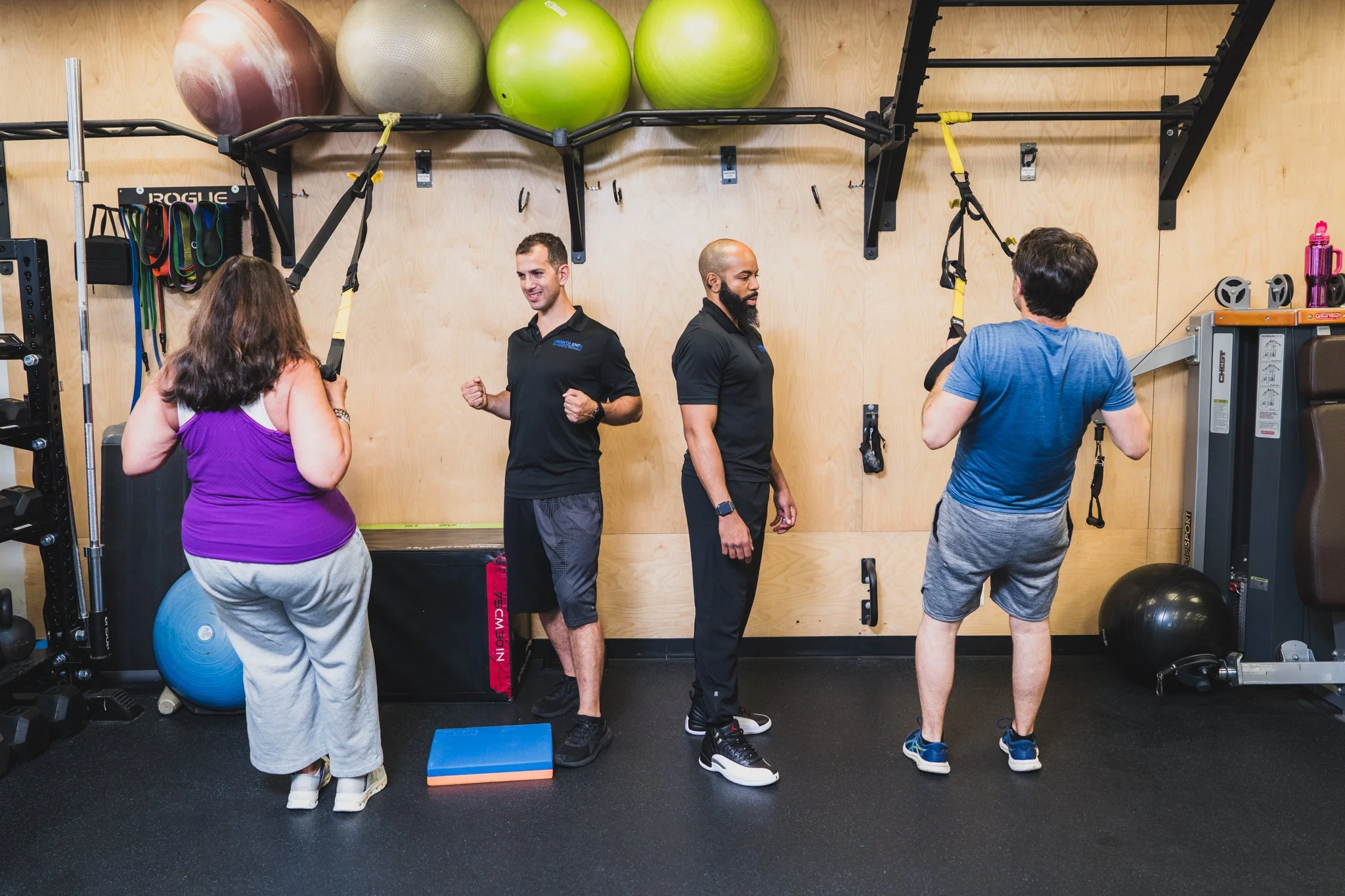 Two personal trainers coaching separate clients through a strength session at North End Fitness in New Rochelle, NY