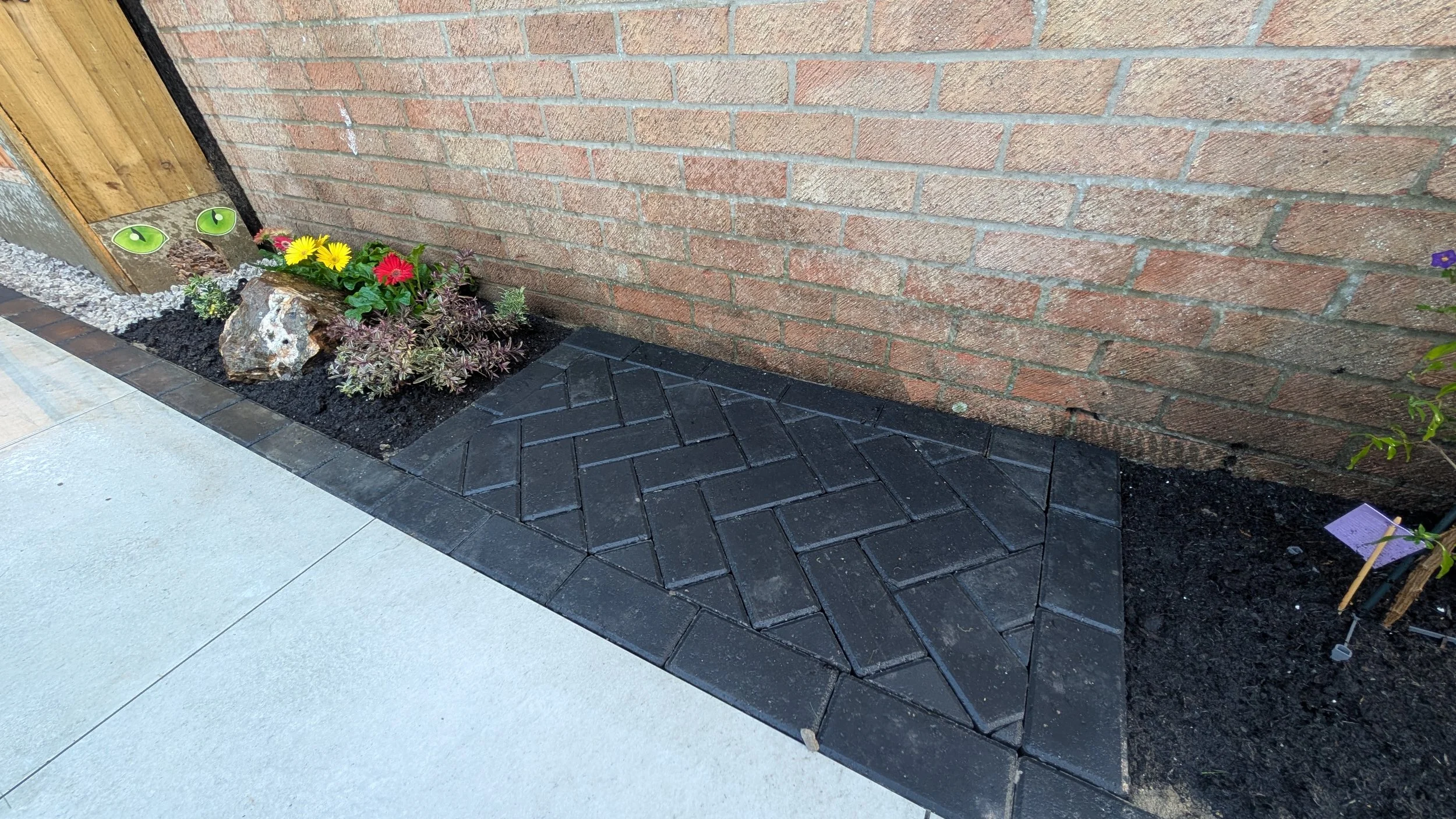Black paved BBQ standing area