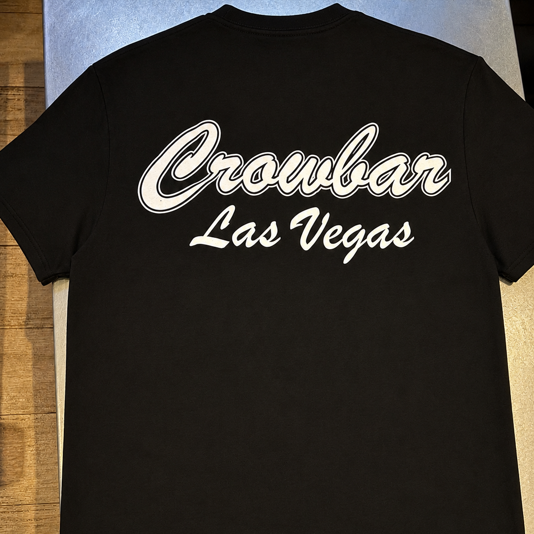 Black T-shirt with white script text reading "Crowbar Las Vegas" on the back.