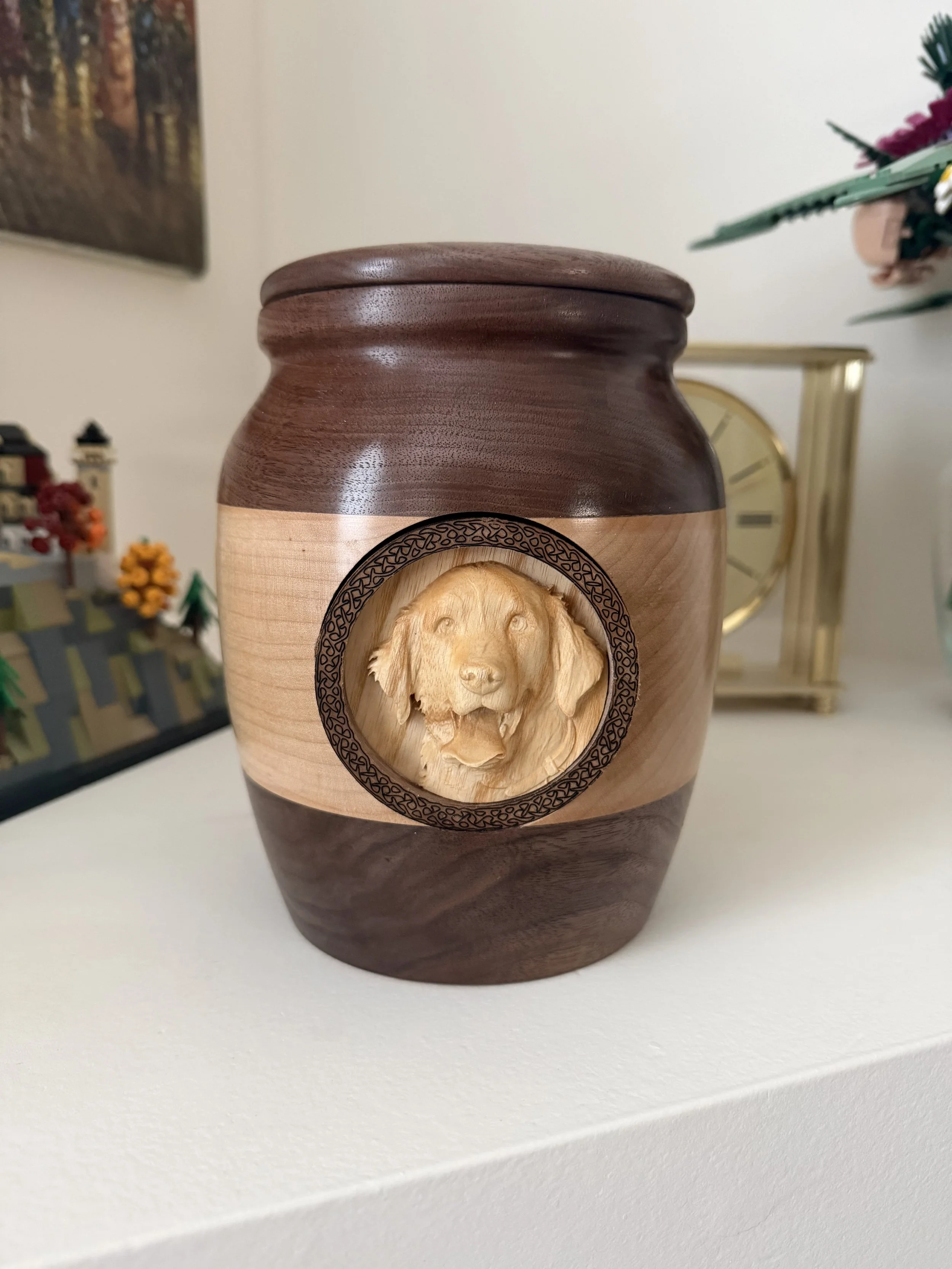 Hand-carved walnut dog urn with engraved portrait relief"