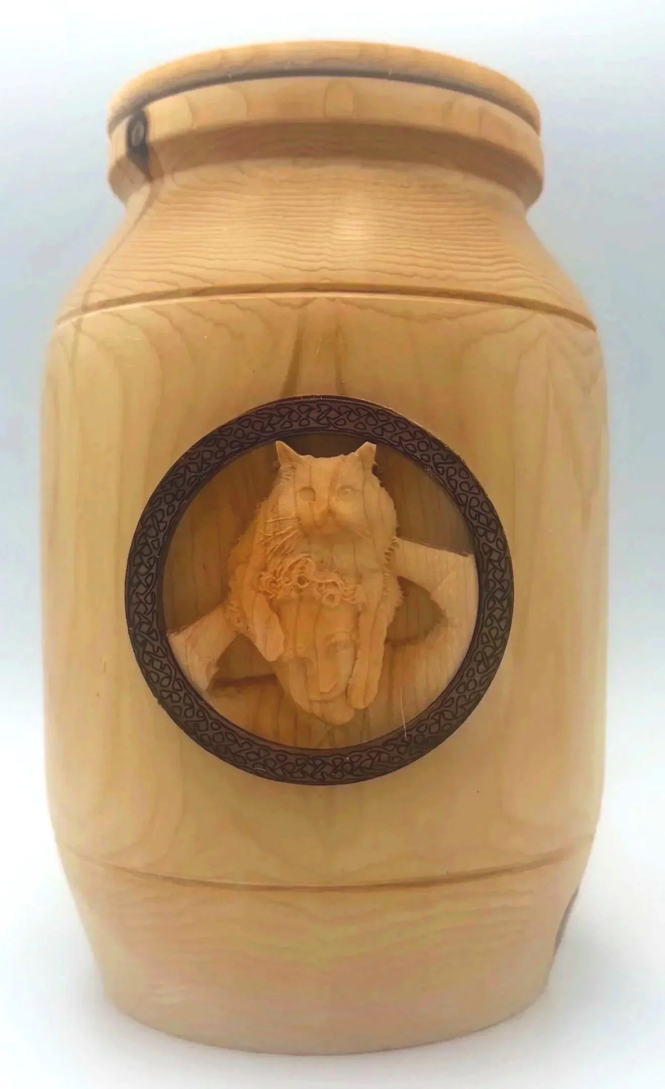 Wooden container with a circular emblem featuring a carved wolf head in the center.