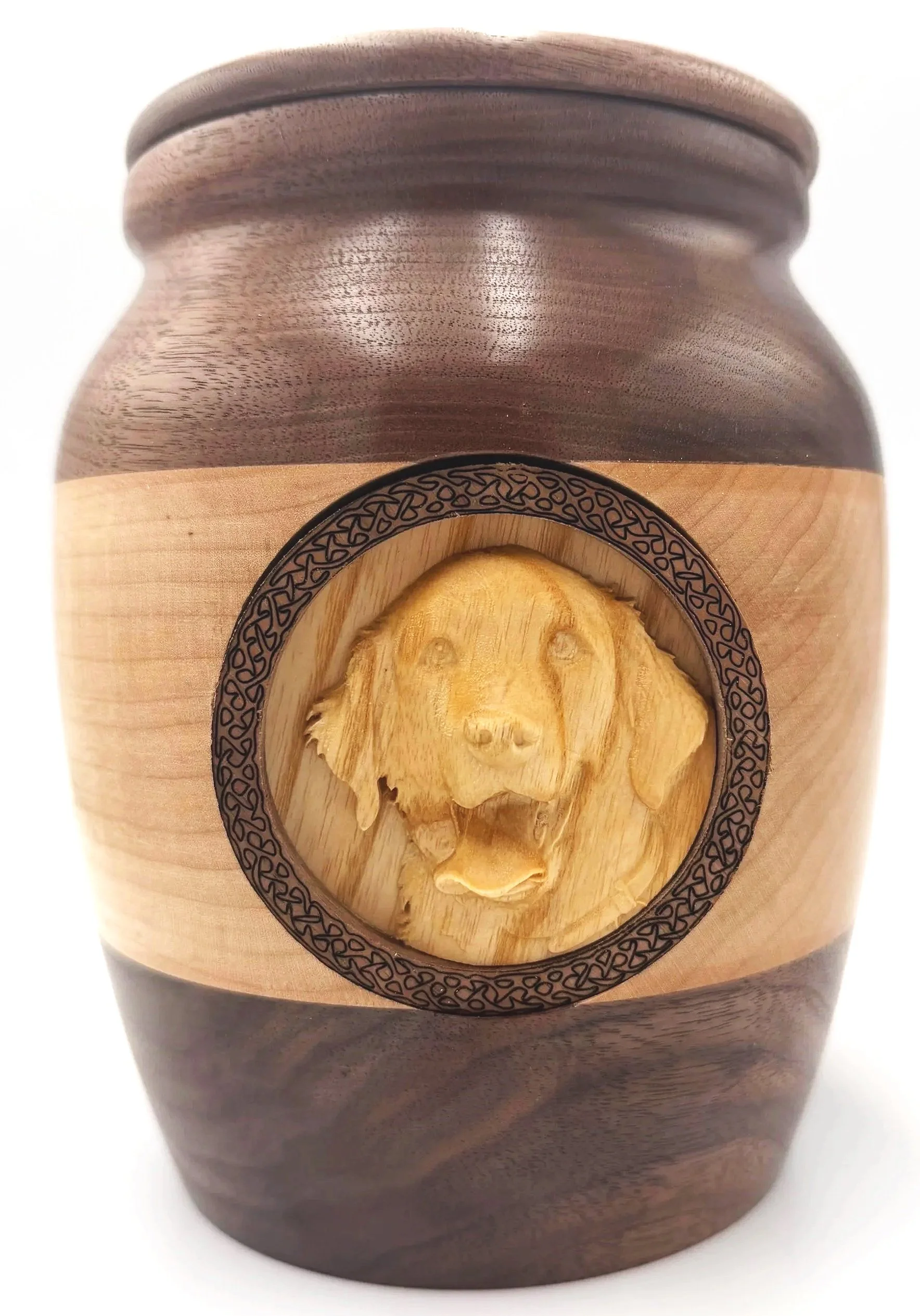 Wooden container with a carved face design on the front, rounded top, and smooth wood grain surface.