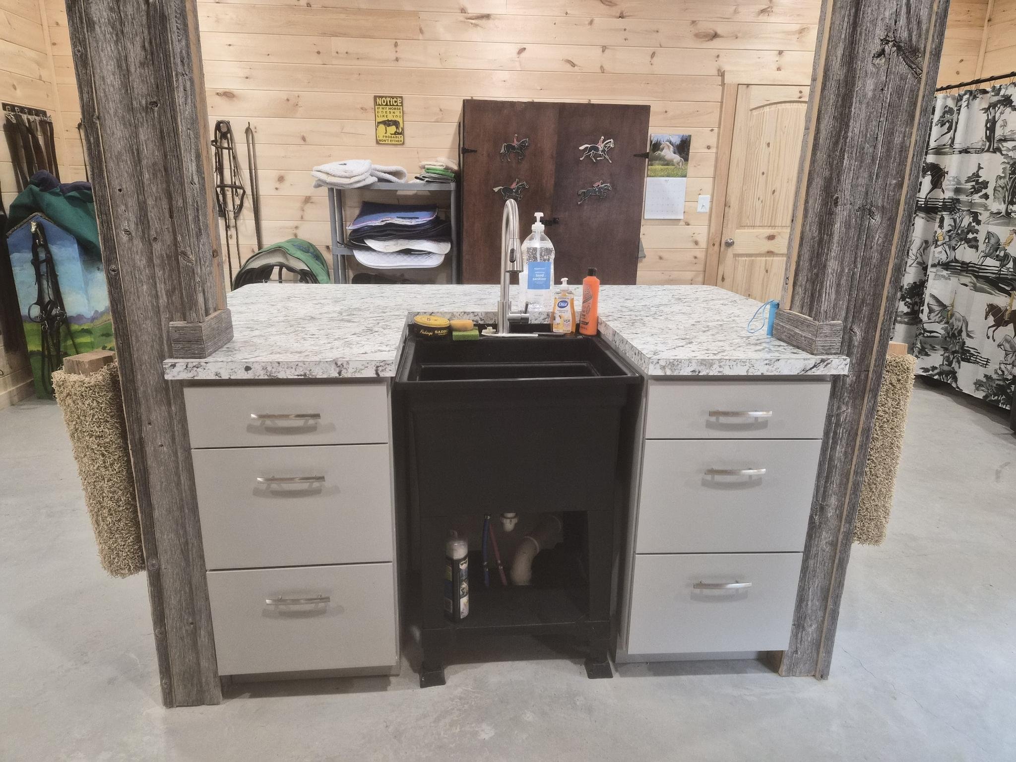 Deep cleaning sink for the tack room with hangers for tack
