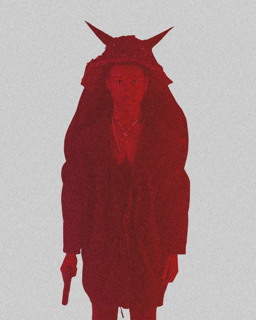 Person dressed in a costume with a horned headpiece, holding a small object, against a plain background.