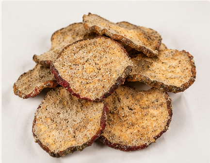 Slice of dehydrated or dried fruit, possibly apple or pear, with a rough, textured surface.