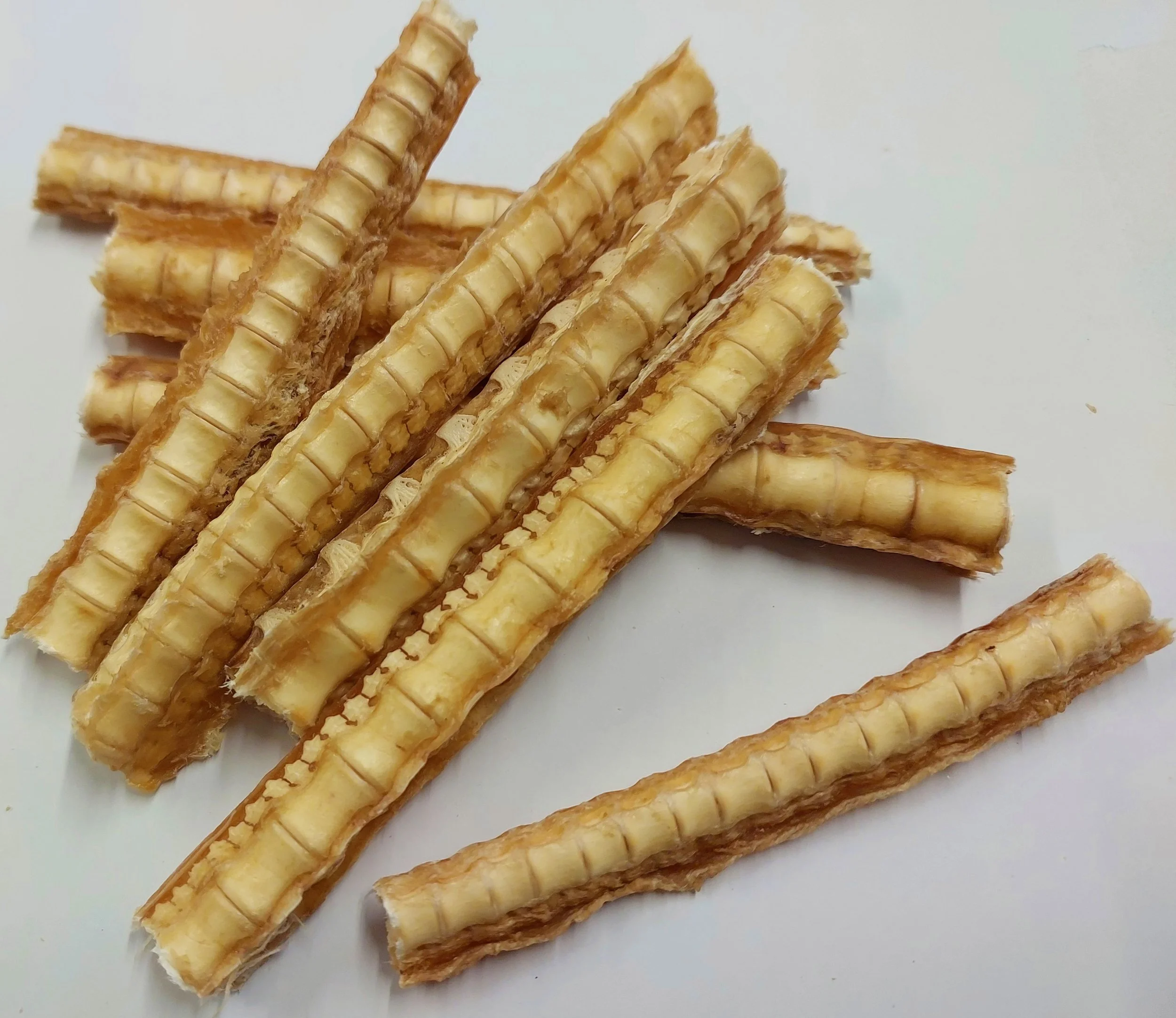 Several crisp waffle sticks with a golden-brown color and visible grid pattern on a white surface.