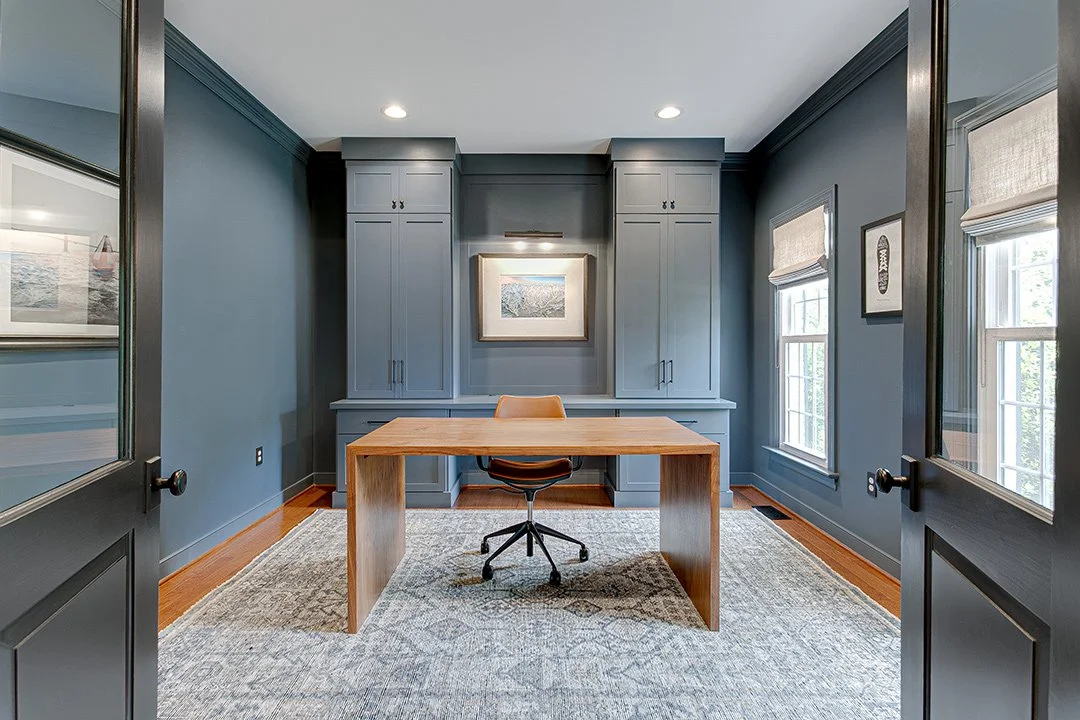 custom home office cabinets with artwork lighting