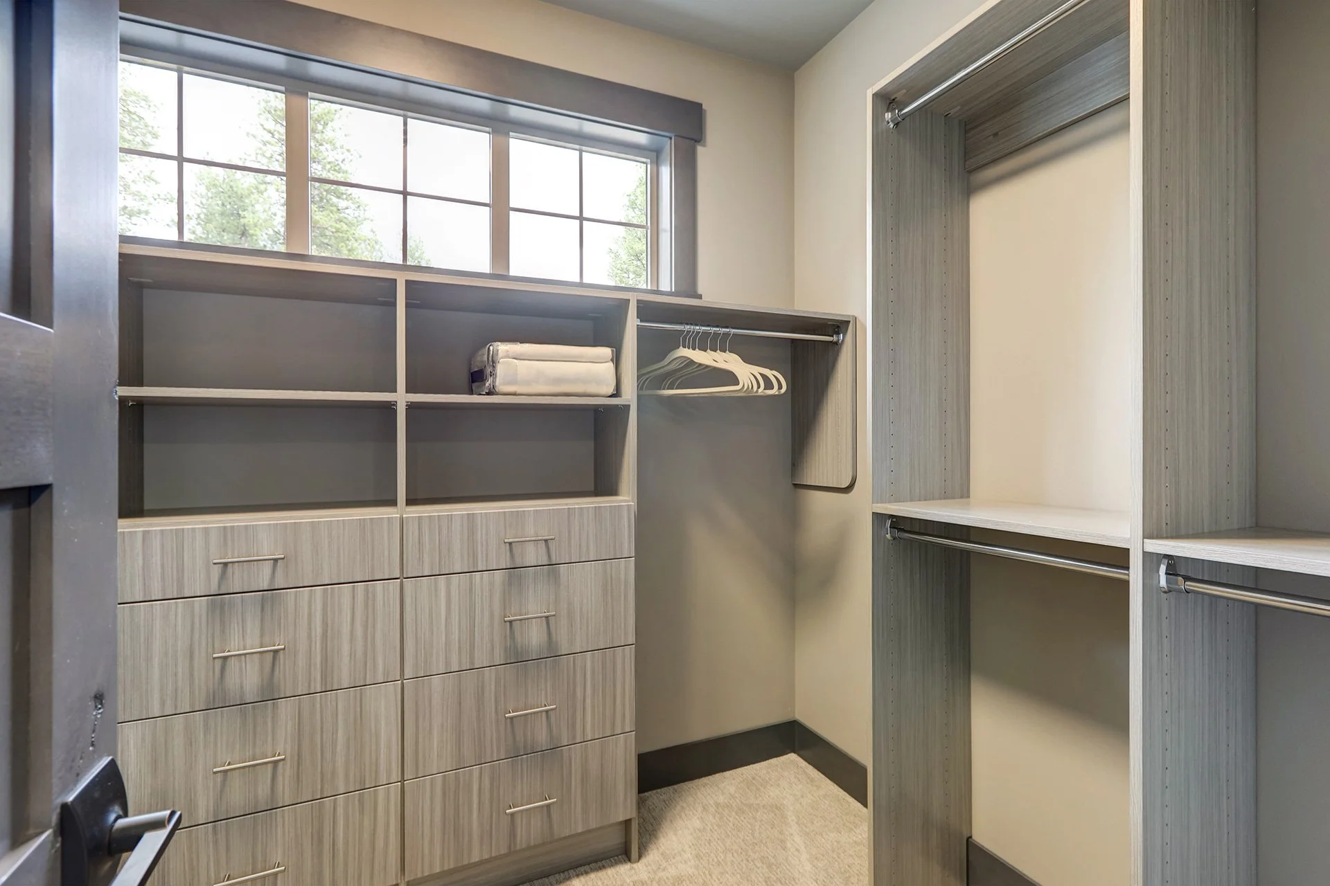 Gray custom closet shelving with drawers and hanging rails