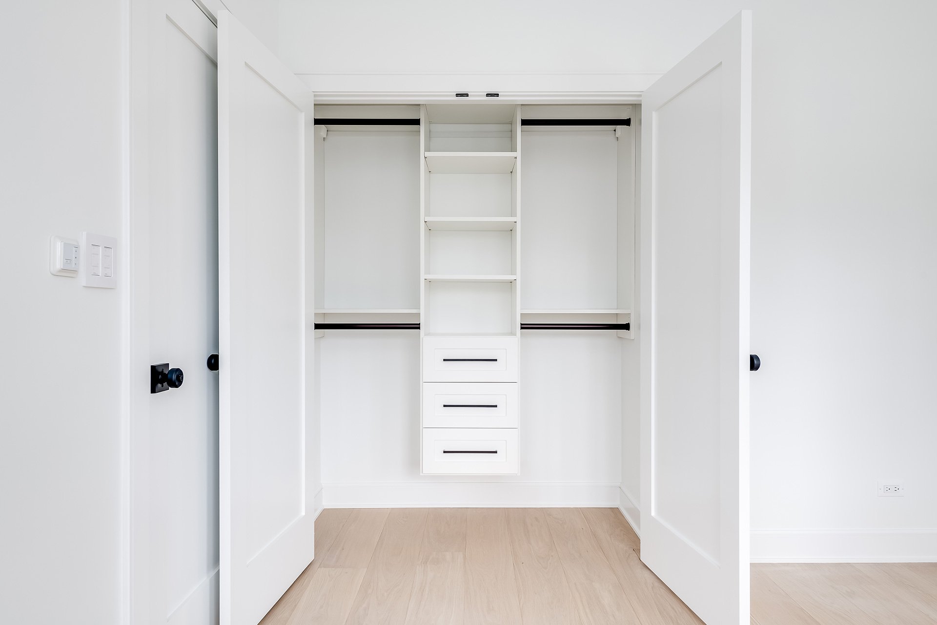 white reach in closet with black hardware in Bend Oregon
