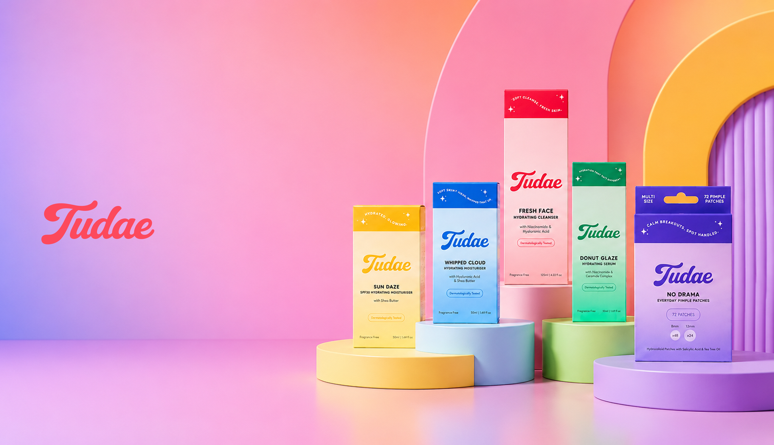 Colorful skincare product boxes from Tudae arranged on pastel-colored pedestals against a gradient pink and purple background, with the Tudae logo on the left.