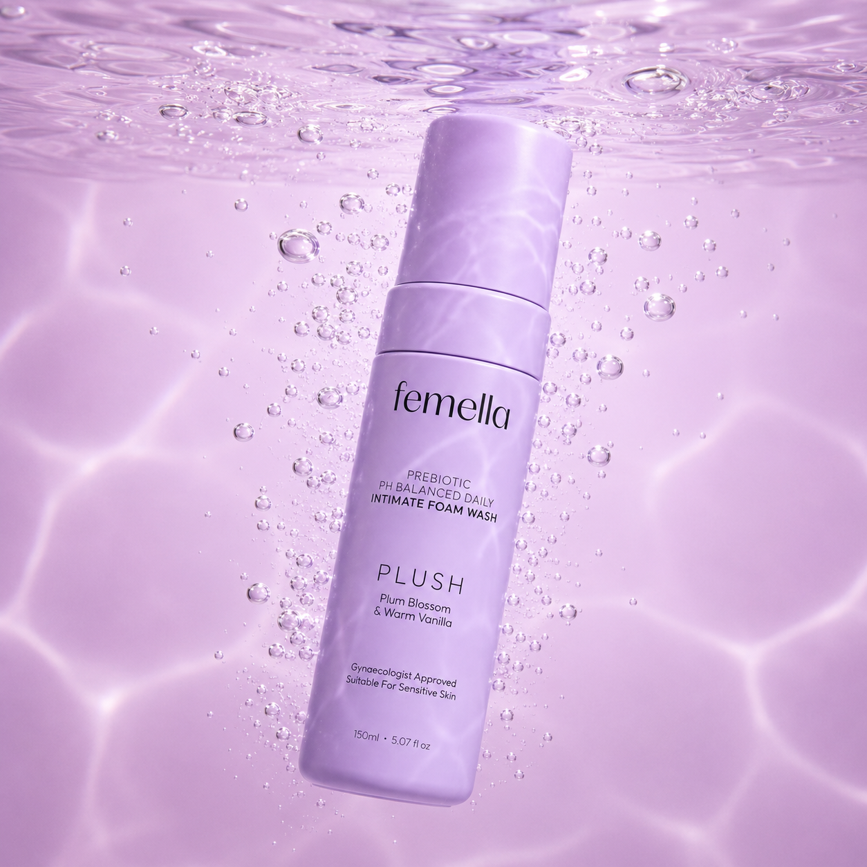 A bottle of Femella Intimate Foam Wash with a lavender color, floating underwater with bubbles and purple light reflections.