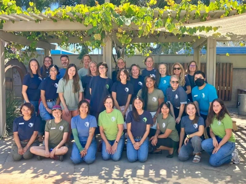 The Ground Education Team of Educators poses for a team photo in their Ground Education t-shirts of varying colors.