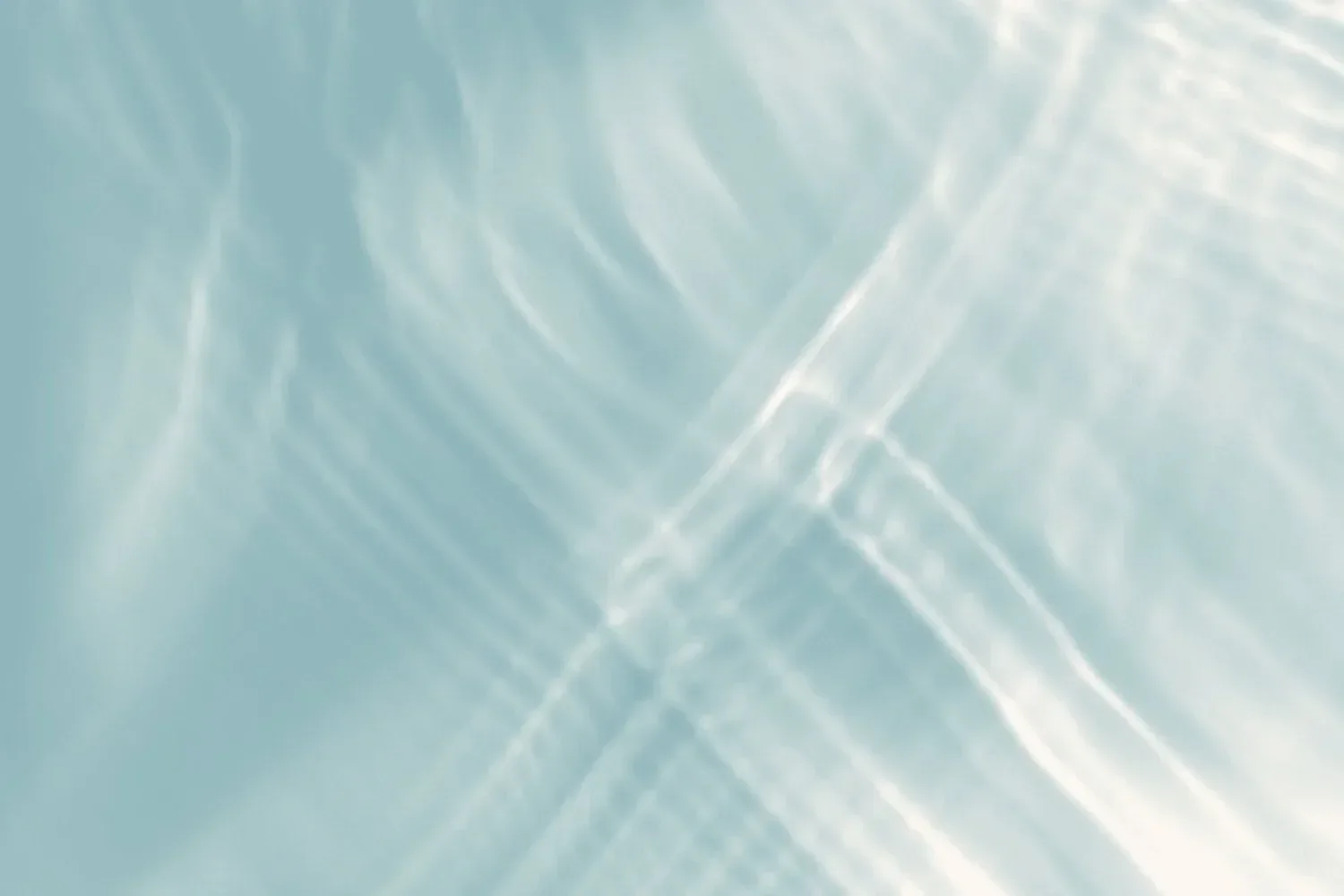 Light blue and white abstract pattern with soft, swirling lines and gentle reflections.
