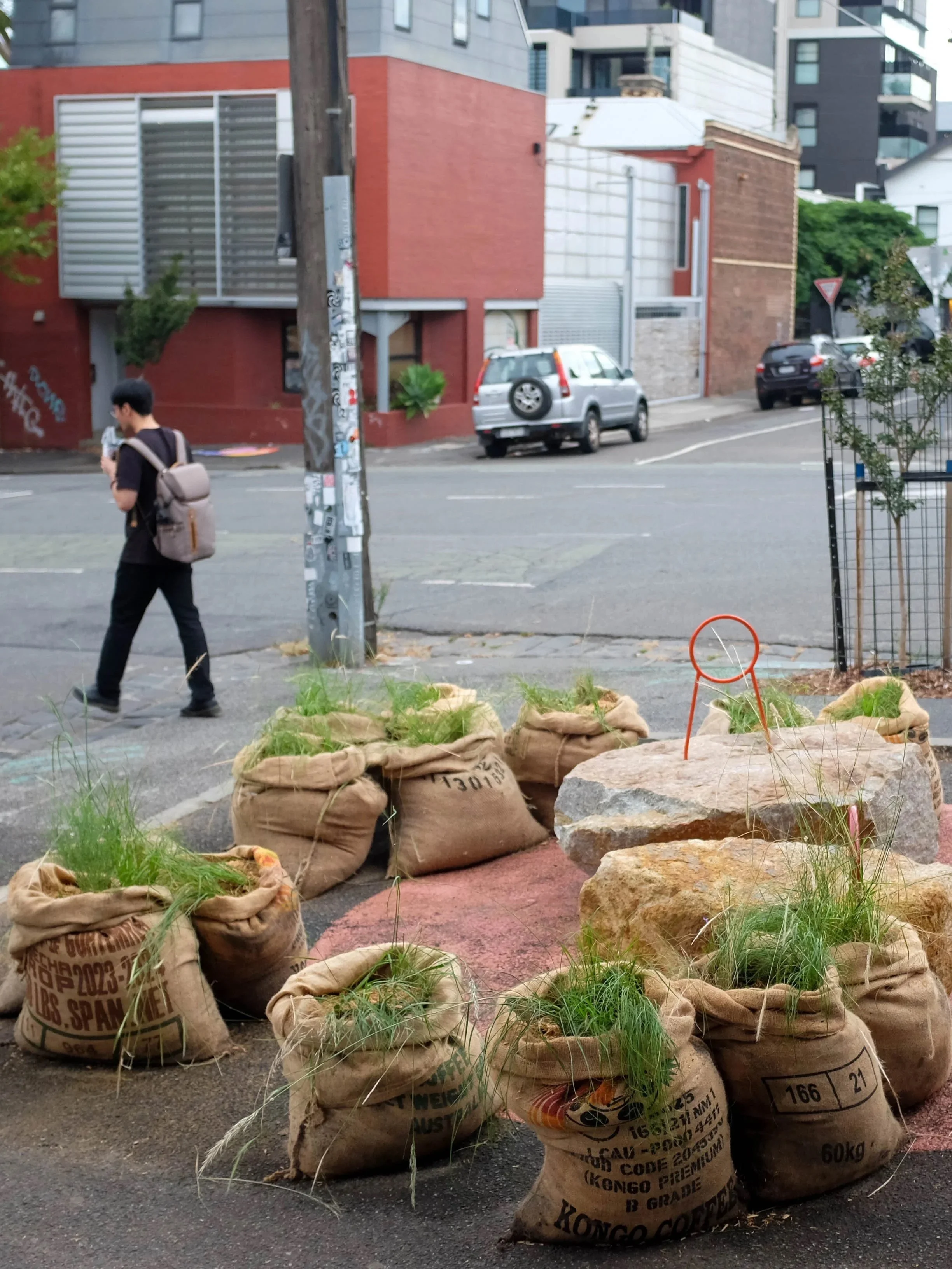 A pedestrian walking past the installation on a Collingwood street