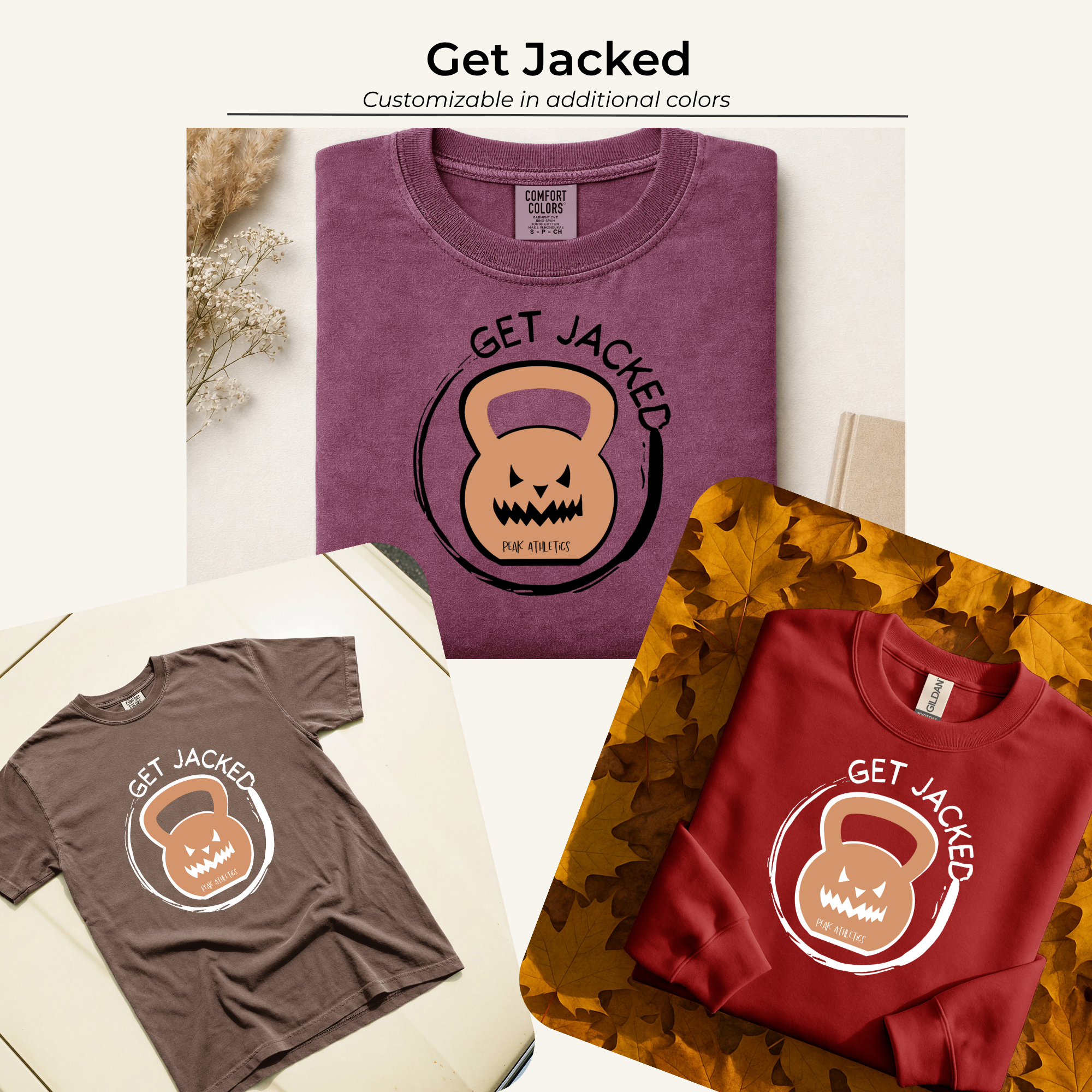 Two folded sweatshirts on a white surface, one purple with Halloween-themed graphic and the words "Get Jacked," and one maroon with same graphic, surrounded by dried flowers, fallen autumn leaves, and a beige book.