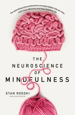 Cover of a book titled "The Neuroscience of Mindfulness" by Stan Rodski, featuring a pink knitted hat with a ball of pink yarn at the bottom and a yarn tail extending from the hat.
