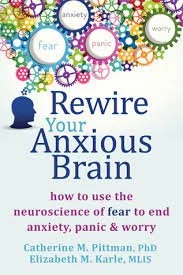 Book cover titled 'Rewire Your Anxious Brain' with colorful gears and words related to anxiety, fear, worry, panic, and mindfulness.