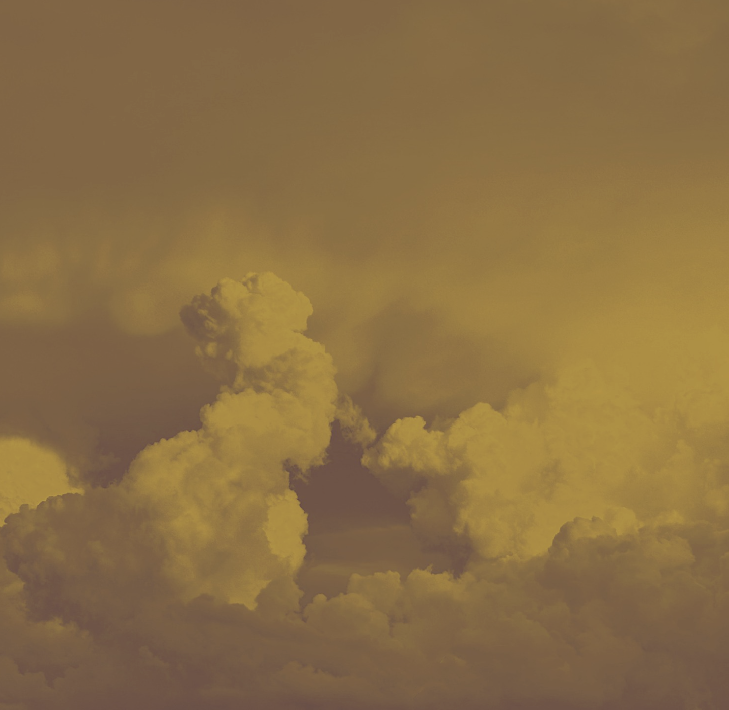 A yellow-tinted sky with cumulus clouds