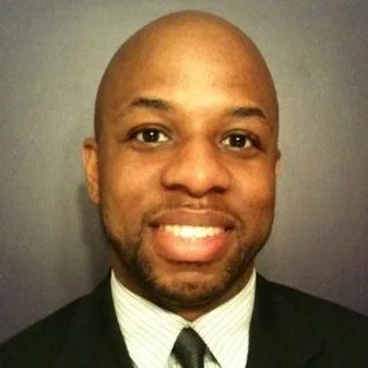 Portrait of a smiling man in a suit and tie.