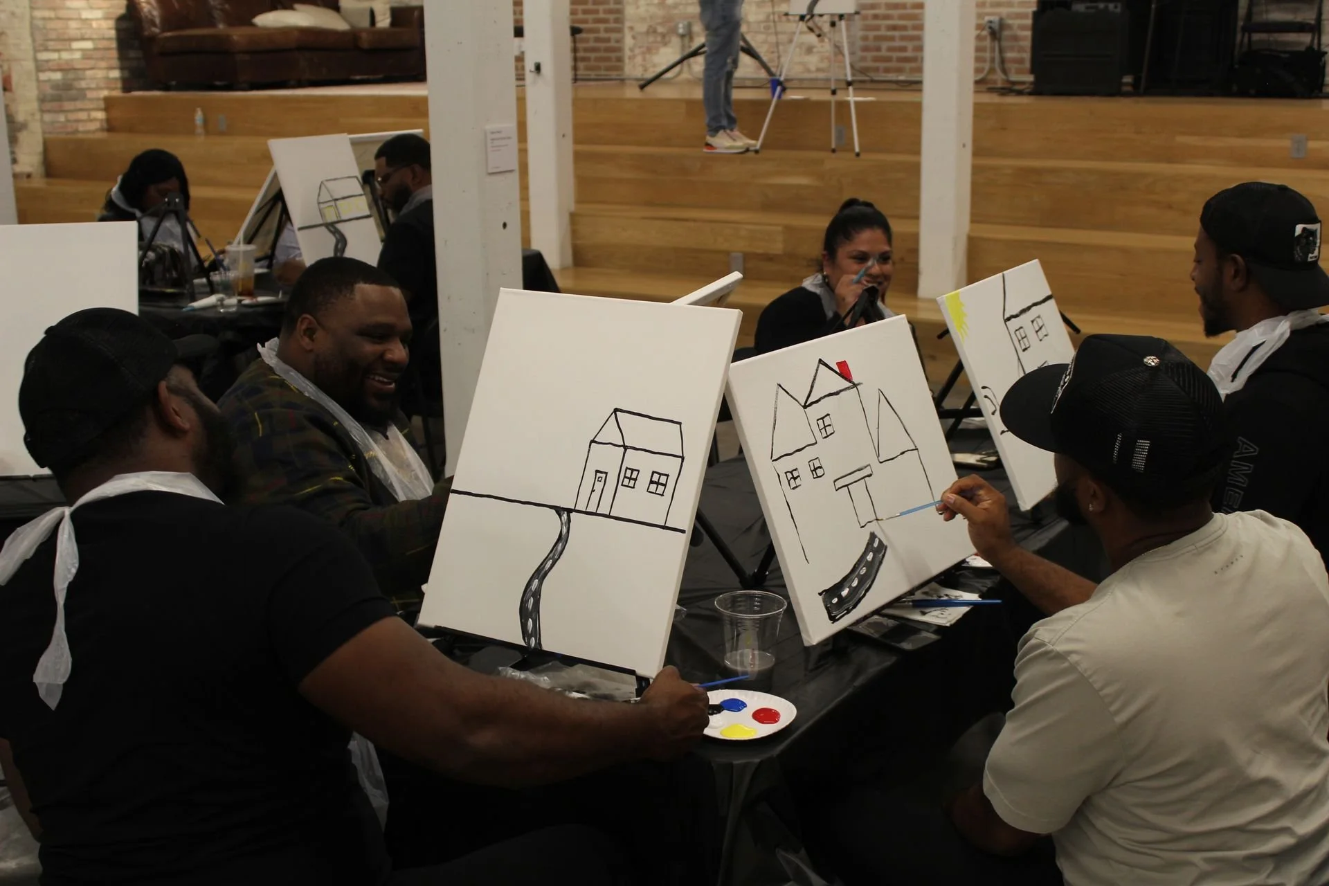 Spit and Paint, a Winning Ways Program. The group all  sitting down and painting  together.