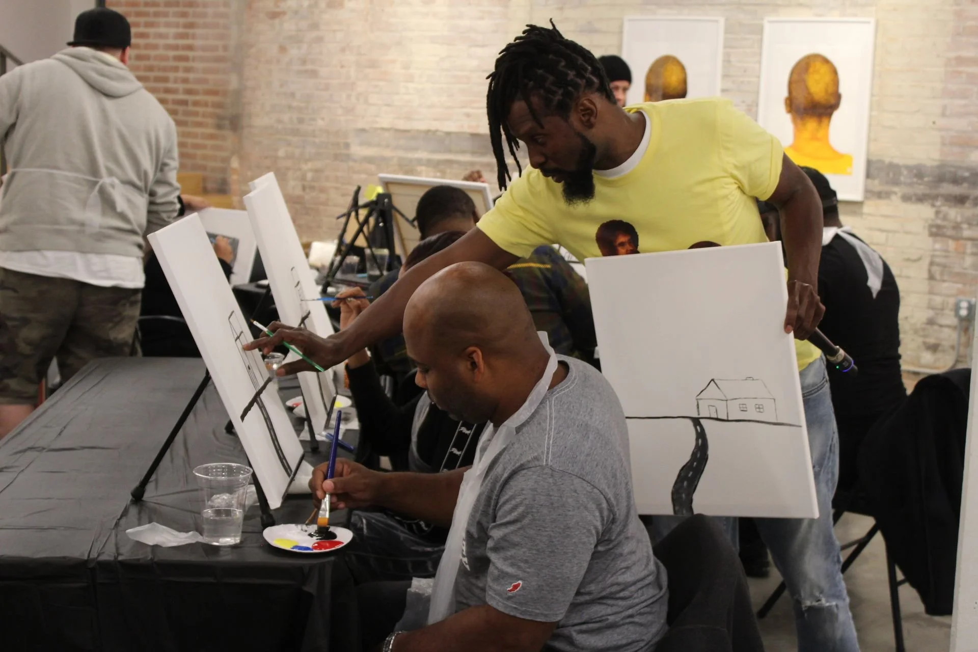 Spit and Paint, a Winning Ways Program. An instructor helping an attendee with their painting.