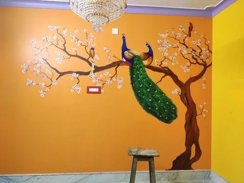 Decorative wall painting of two peacocks perching on a flowering tree branch, with a chandelier hanging above and a small wooden stool in front.