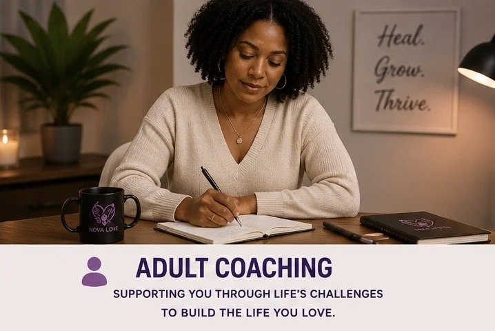 A woman sitting at a desk, writing in a notebook, with a mug and a closed planner, in a cozy room with a framed motivational quote on the wall that says 'Heal. Grow. Thrive.'