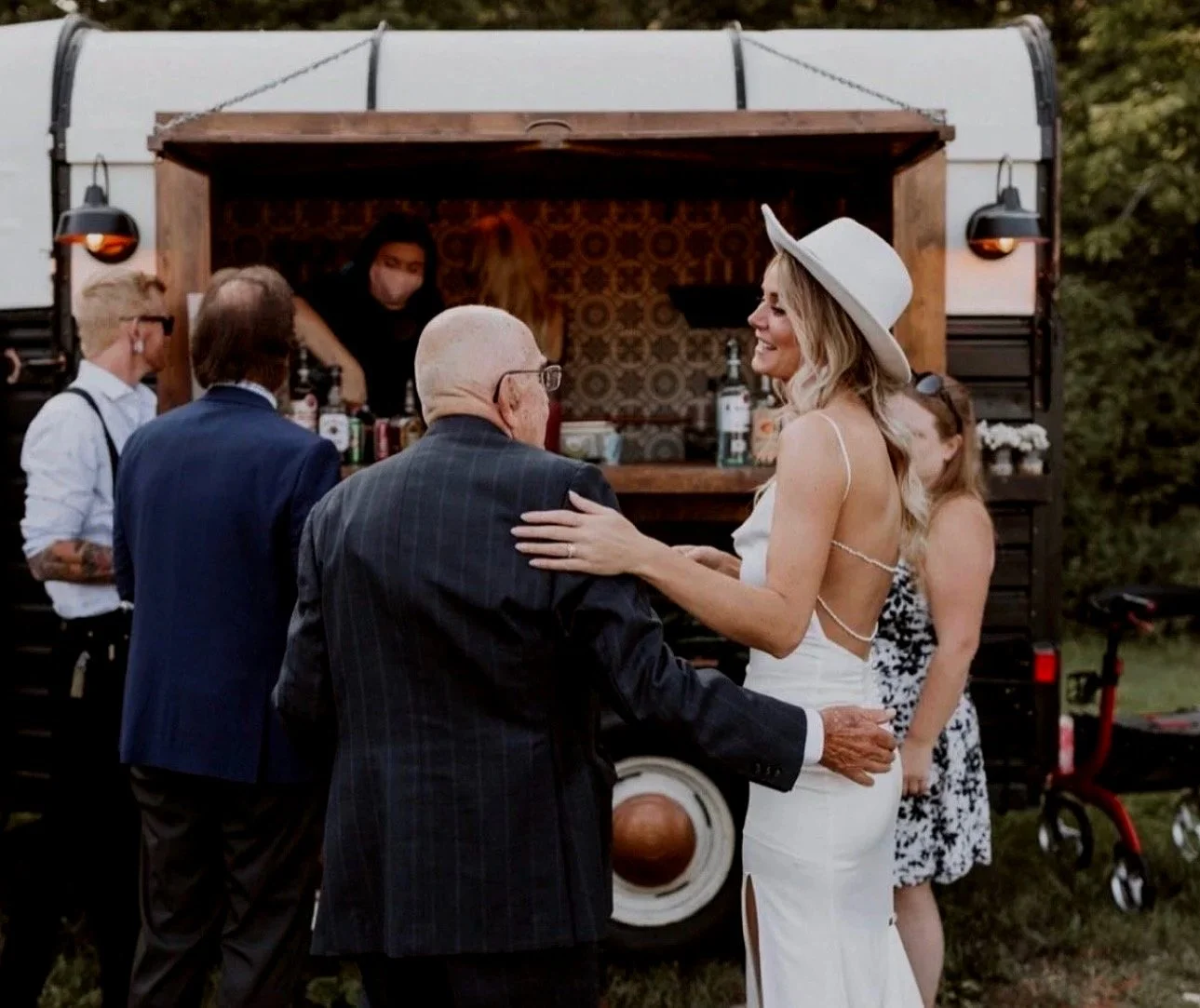 Guests gathering around Amora's mobile bar.