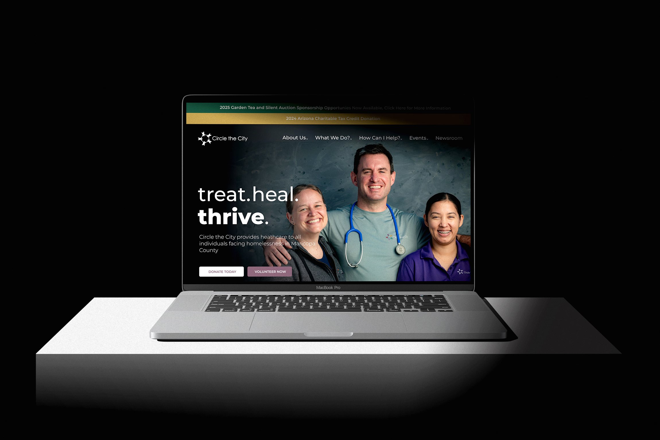 Laptop displaying Circle the City website featuring smiling healthcare professionals promoting services for the homeless in Maricopa County.