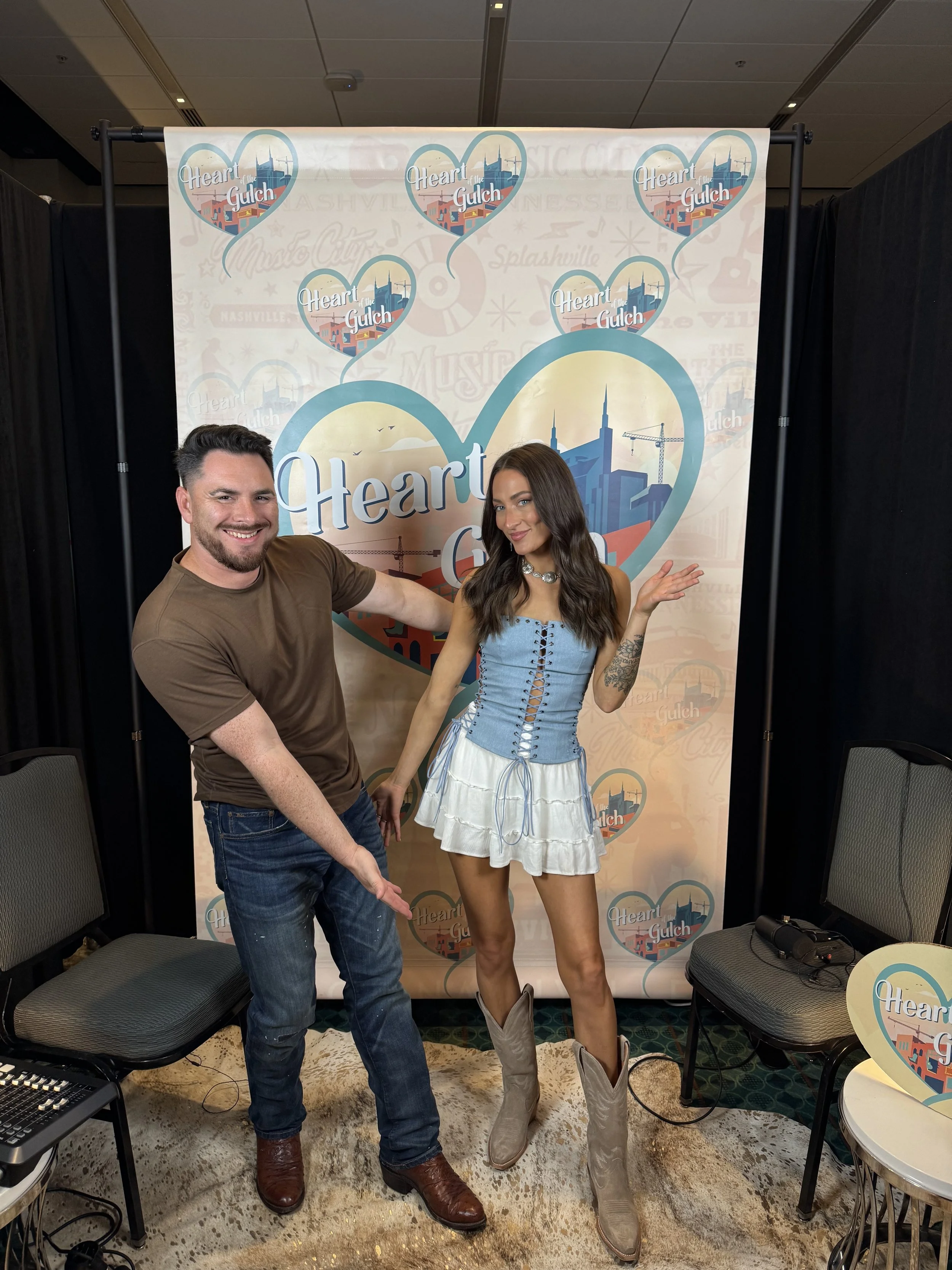Tony Mendoza and country singer-songwriter Hannah McFarland pose together following their Heart of the Gulch interview during CMA Fest in Nashville.