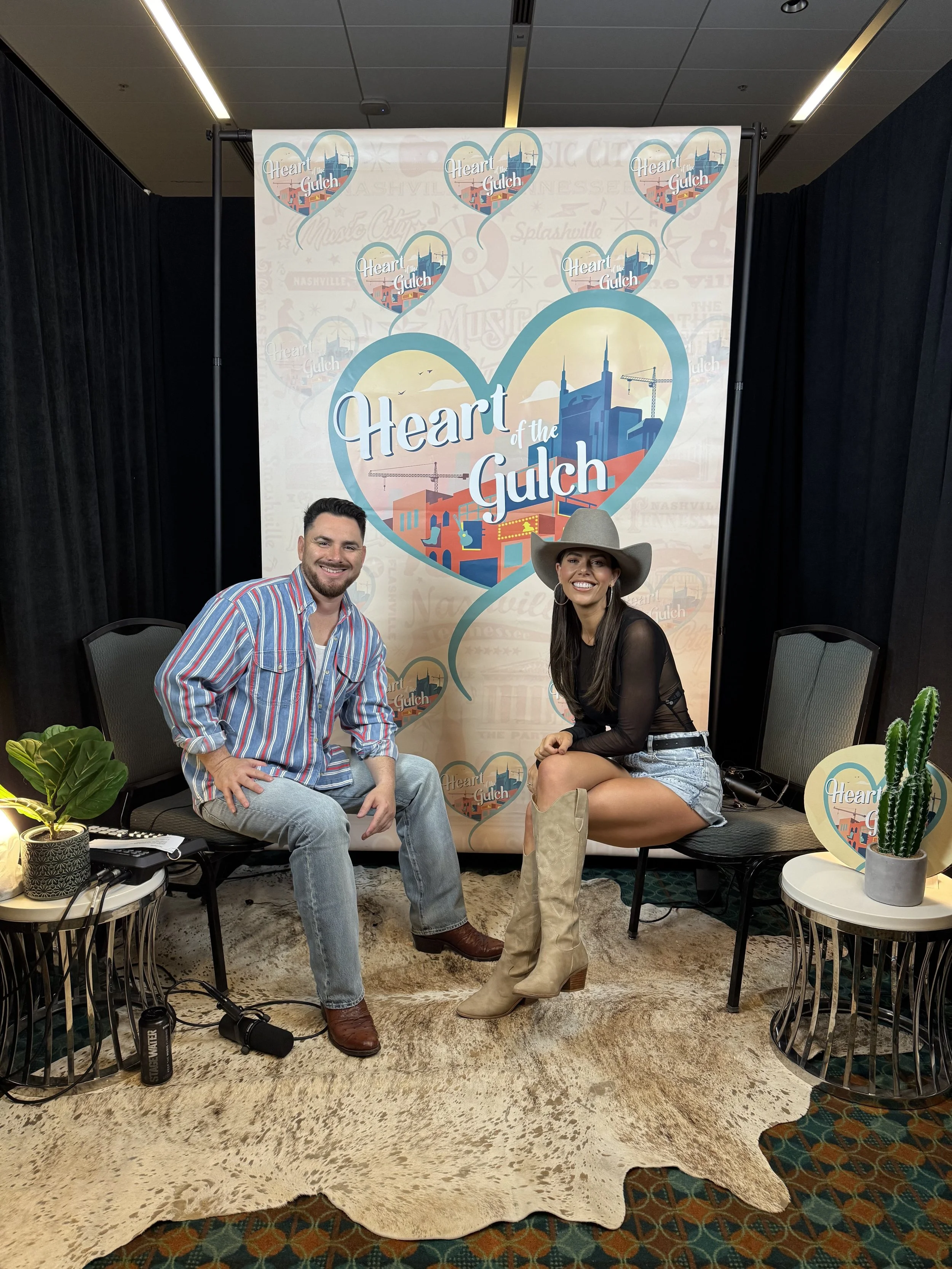 Tony Mendoza, host of Heart of the Gulch, and Tori Darke pose together after their CMA Fest 2025 interview in Nashville.