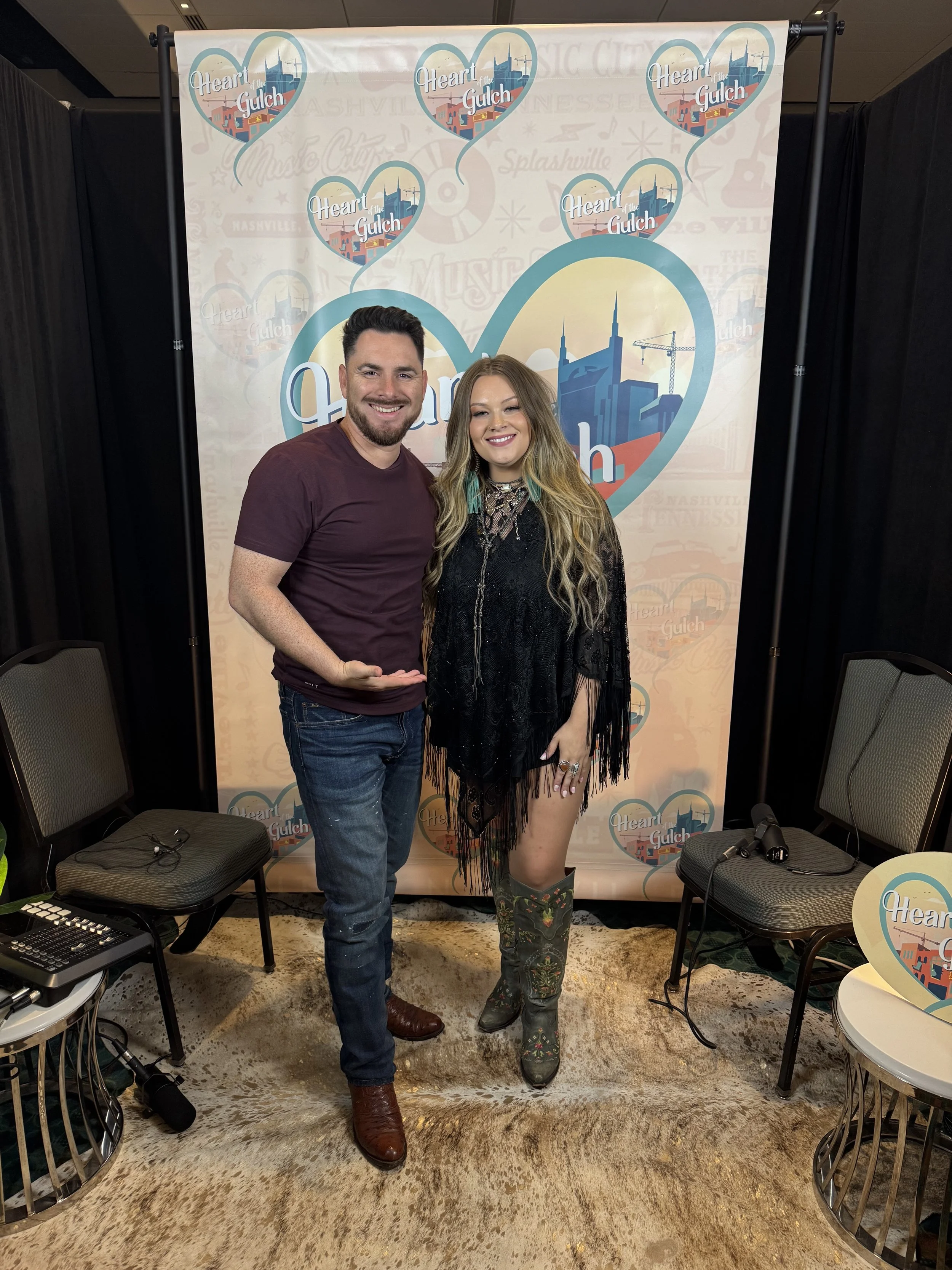 Tony Mendoza, host of Heart of the Gulch, and Ashland Craft pose together after their CMA Fest 2025 interview in Nashville.