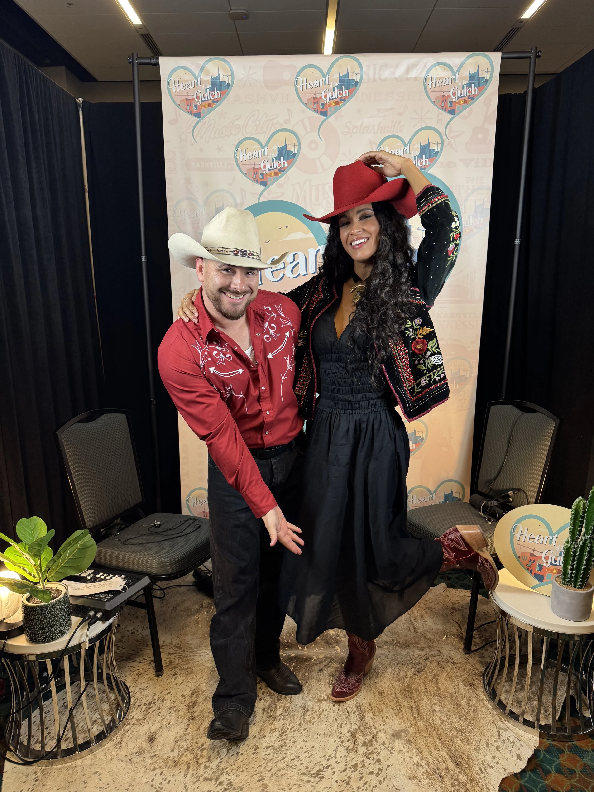 Tony Mendoza, host of Heart of the Gulch, and MŌRIAH Smallbone pose together after their CMA Fest 2025 interview in Nashville.