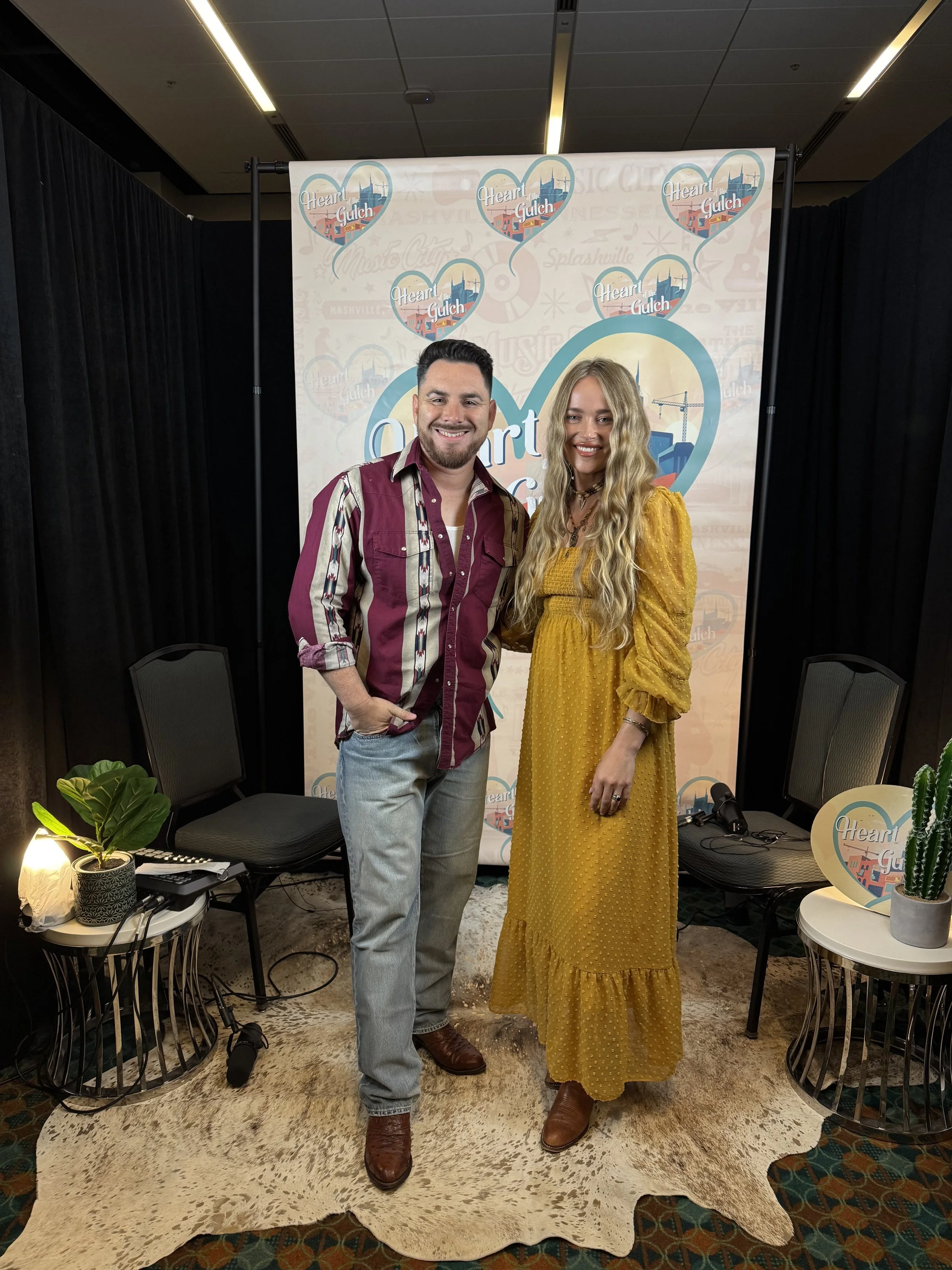 Tony Mendoza and singer-songwriter Leah Blevins pose together following their Heart of the Gulch interview during CMA Fest in Nashville.