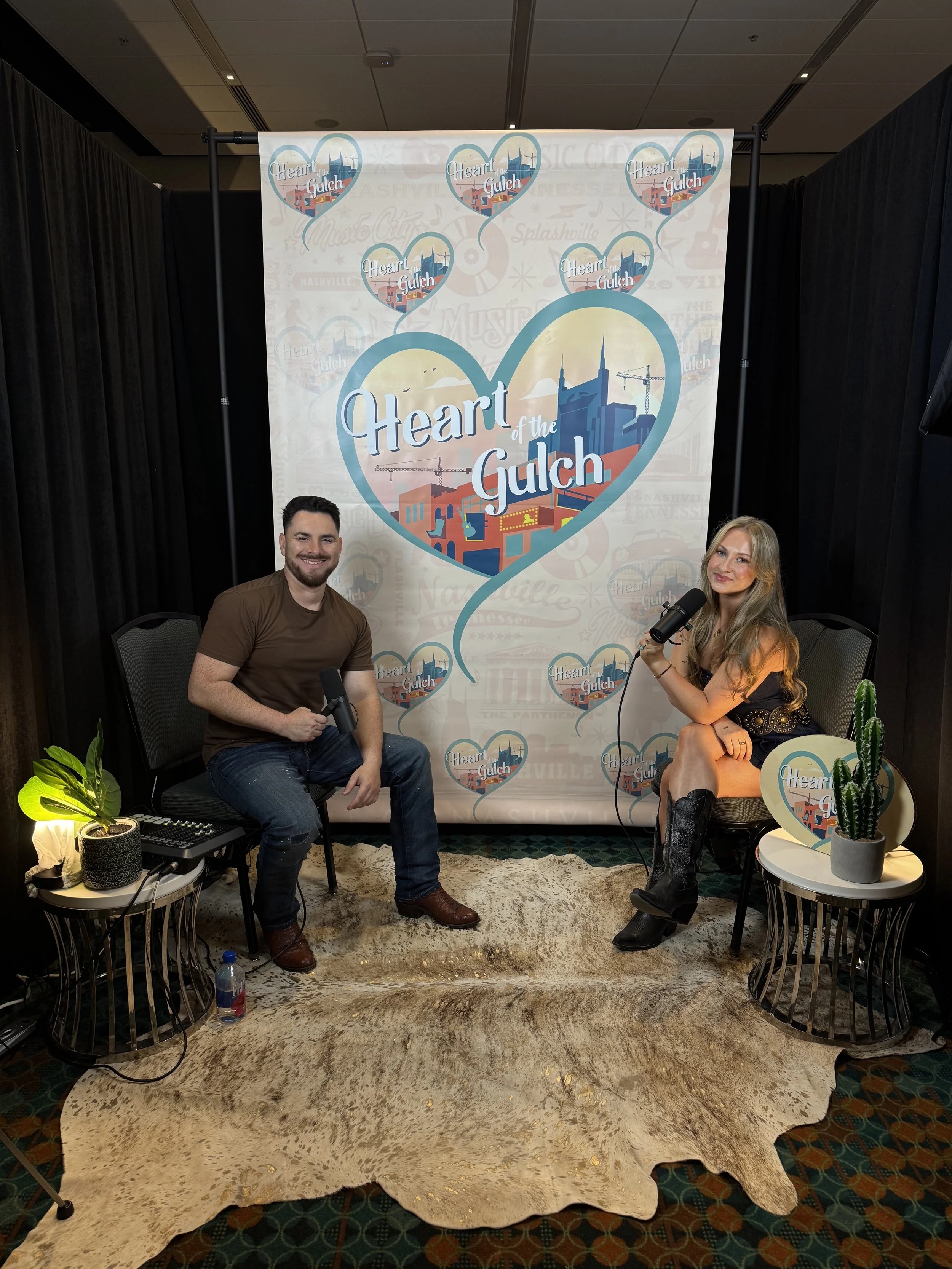 Tony Mendoza, host of Heart of the Gulch, and Ashley Kutcher pose together after their CMA Fest 2025 interview in Nashville.