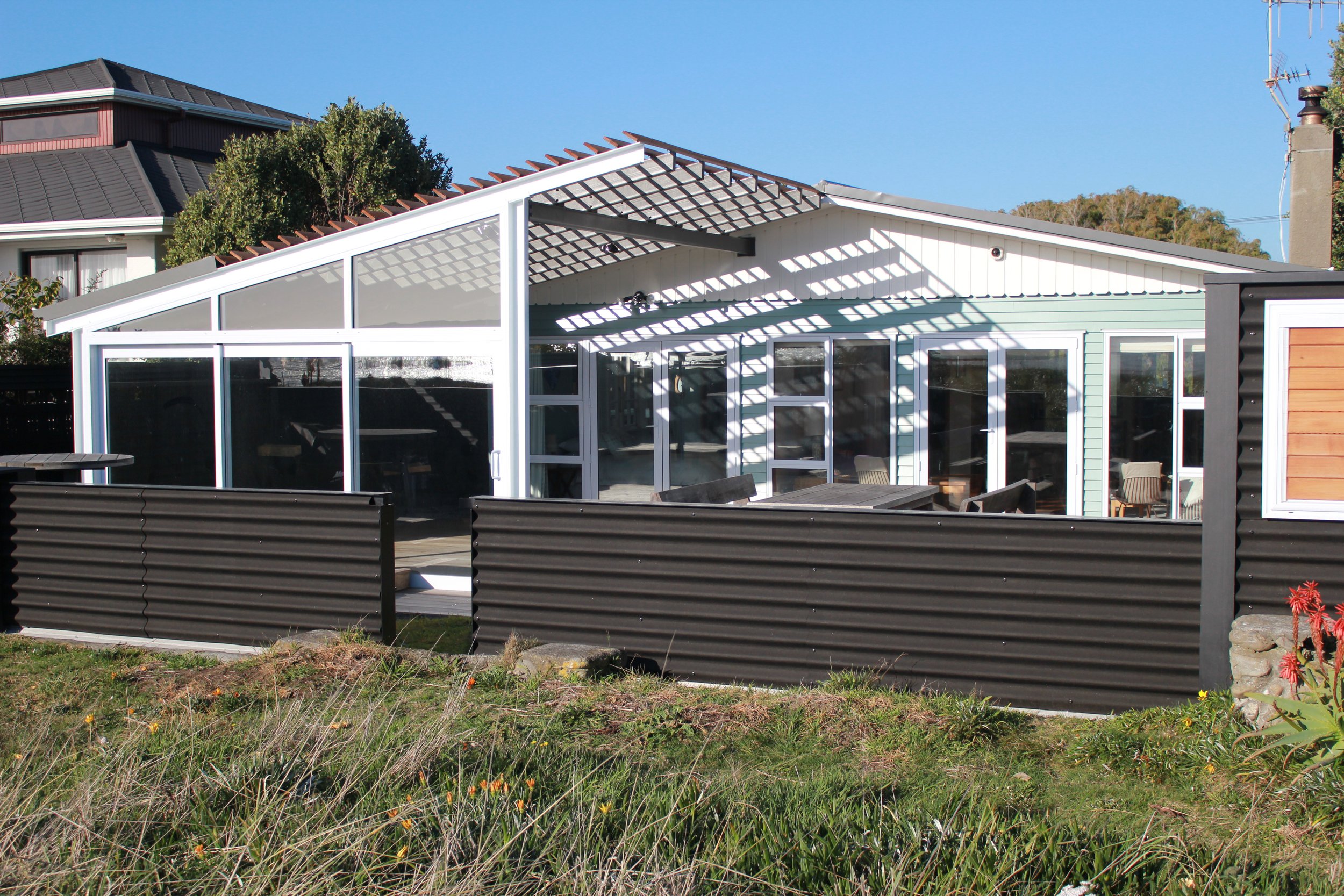 Refreshed house exterior with new semi covered outdoor living space and fence