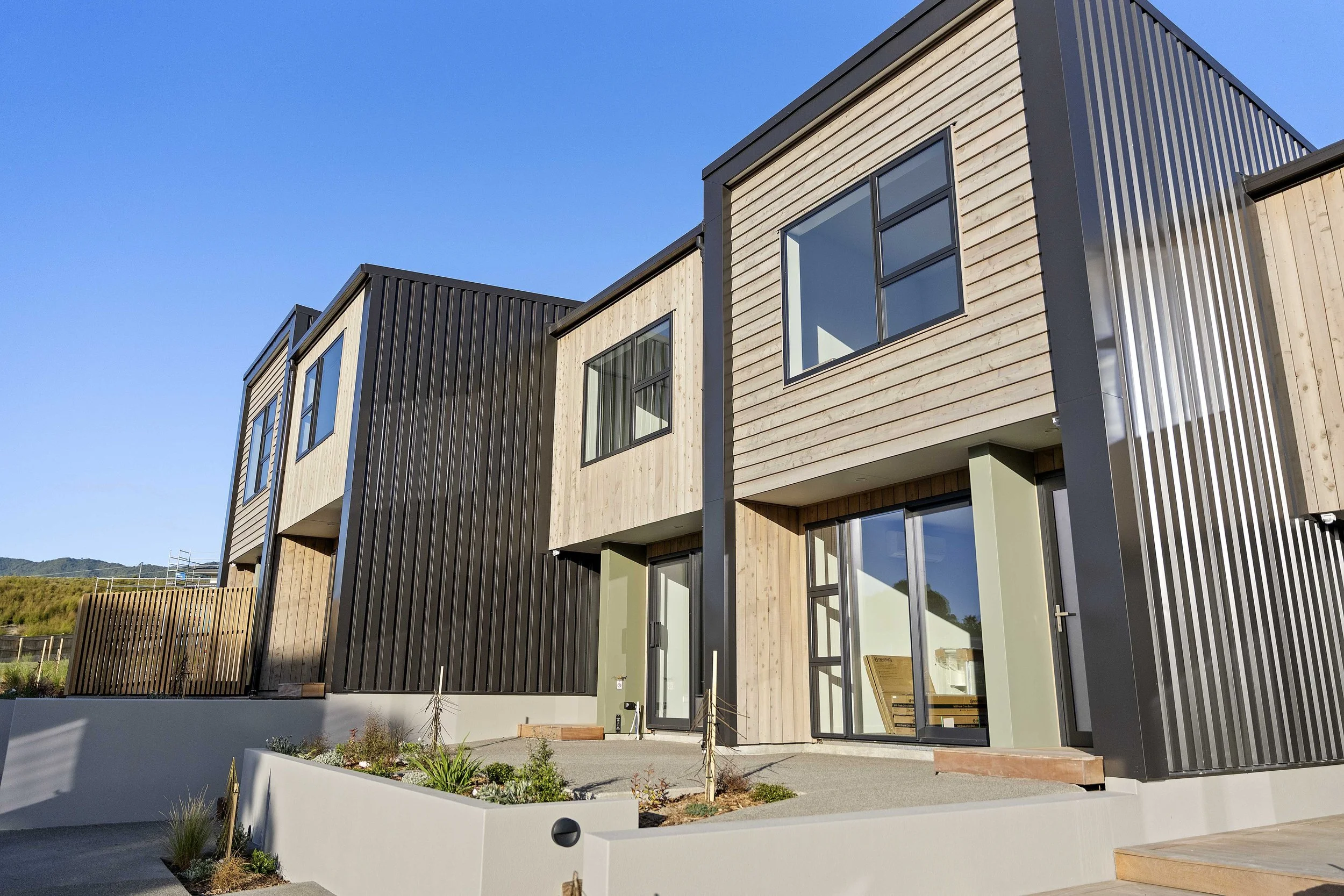 Mix of macrocarpa and metal claddings